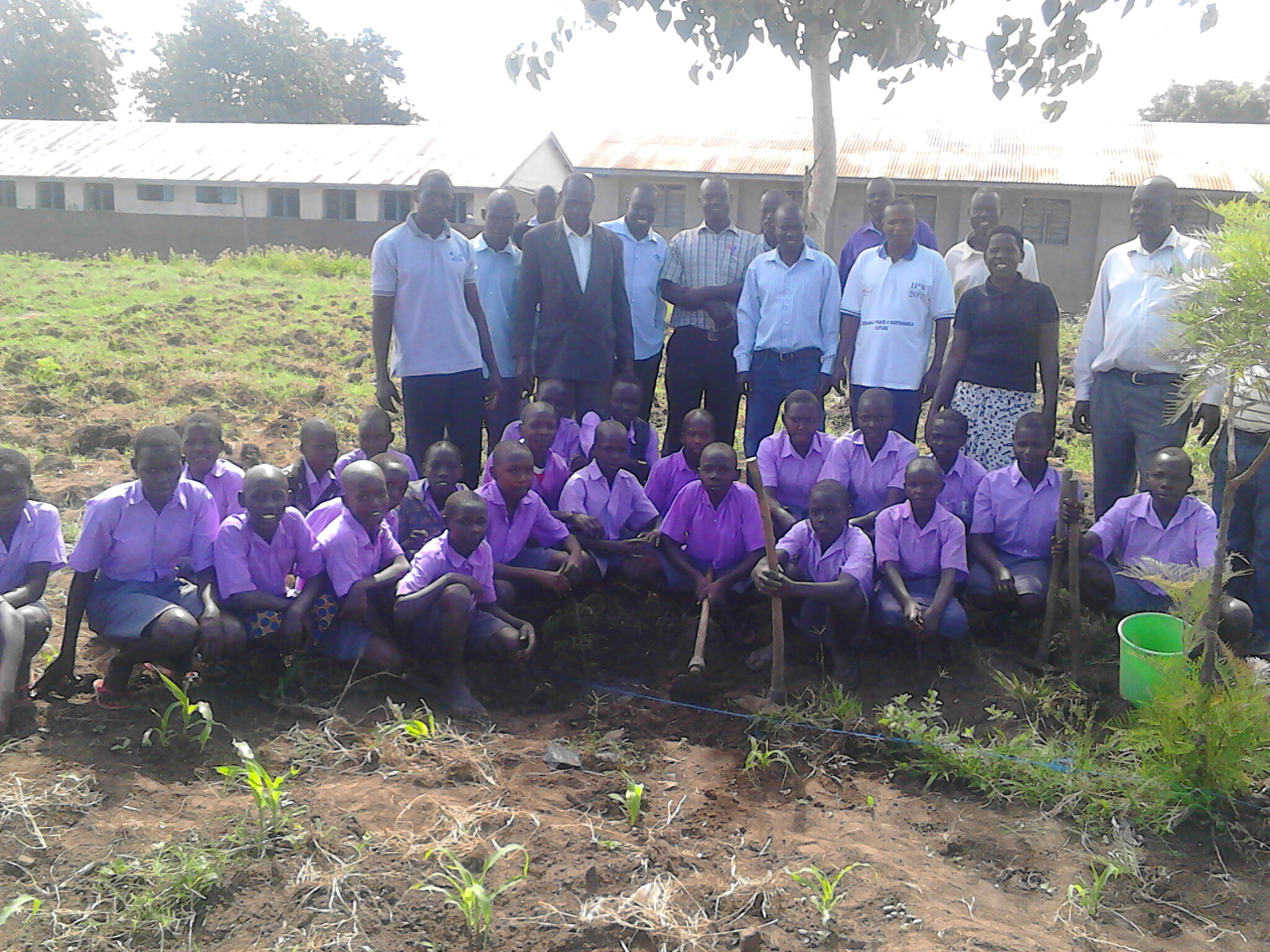 Students and teachers with newly planted seedlings