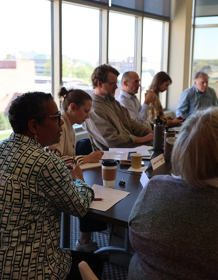 A row of workshop participants at a table - Steve Willborn, Loka Ashwood, Adam Thimmesche, Levi Van Sant, Sabrina Ehmke Sergeant, Catherine Wilson, and Mary Hendrickson