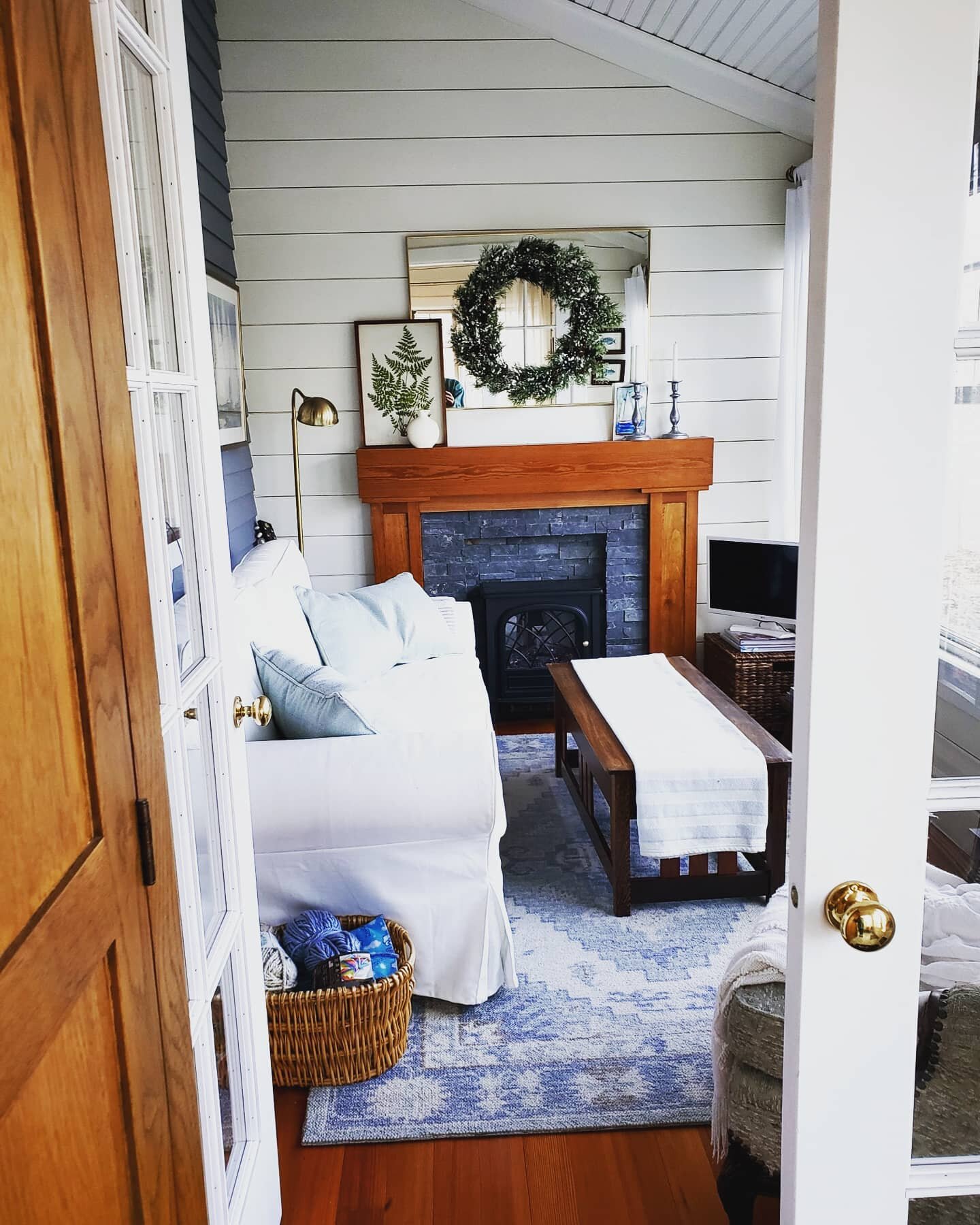 How to turn a rarely used front porch into a cozy room. Swipe for the before! #custommantel #customfrenchdoors #shiplapwalls