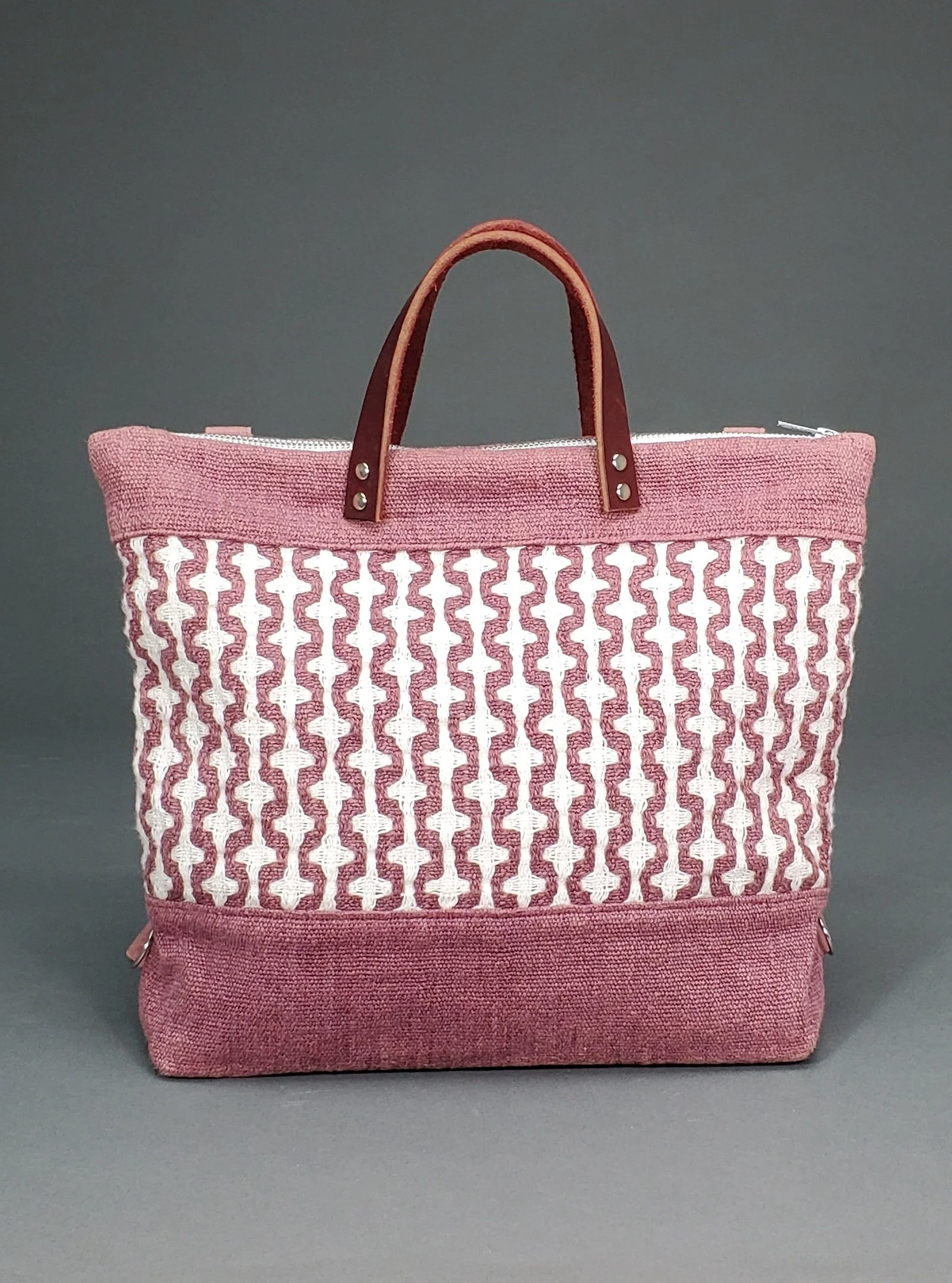 Corrib Carrier: Woven linen handbag (2021) Handwoven linen, natural dye (sappanwood), repurposed leather strap, cotton lining, zipper, handbag findings,  14” x 12”
