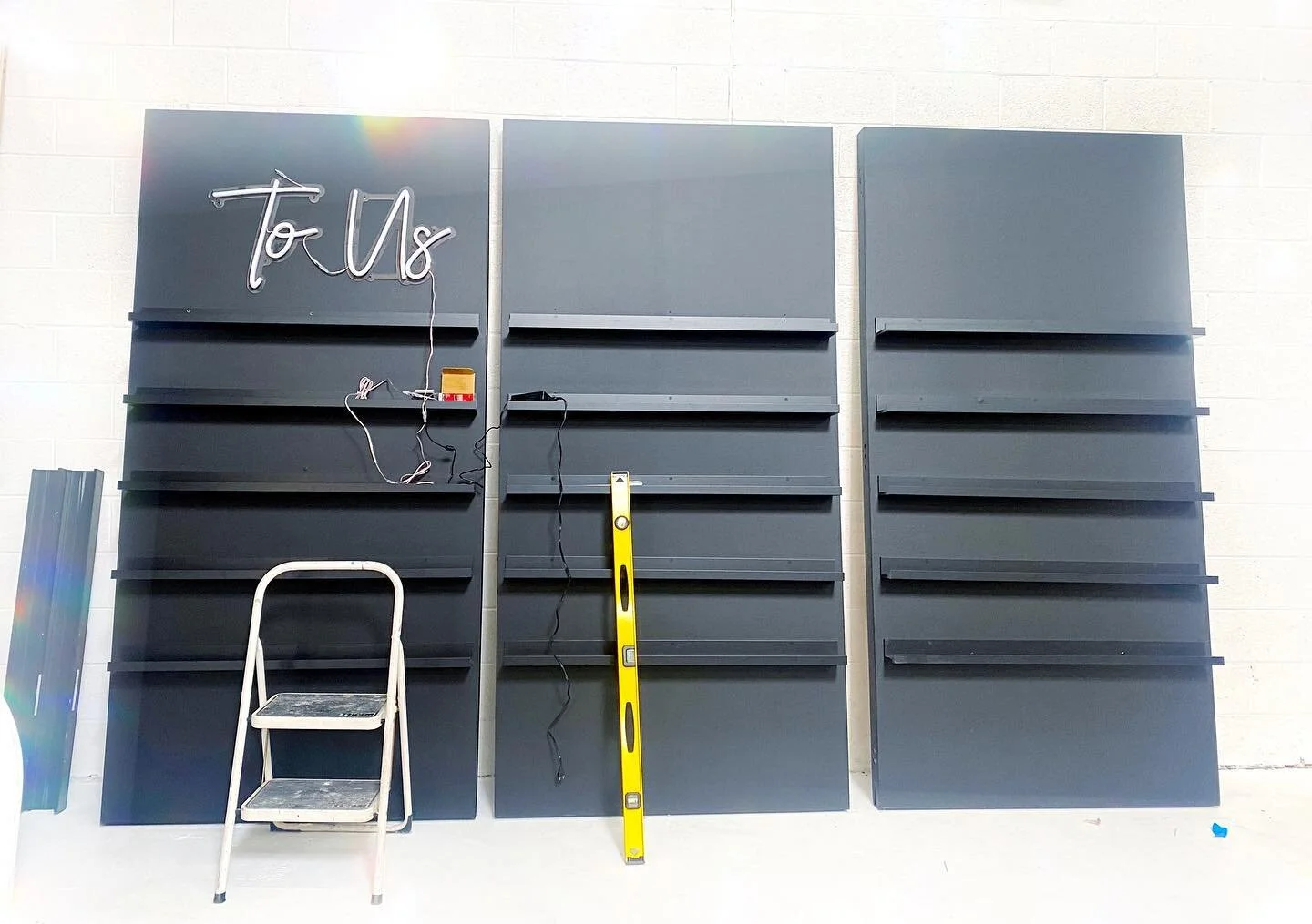 CHEERS TO US ⚡️
.
Popping lots of bottles to fill these walls with BUBBLY this weekend. Not every picture is of the glamorous finished variety. This one is the BTS of getting the shelves JUST RIGHT! We revamped these babes and tested out the neon...
