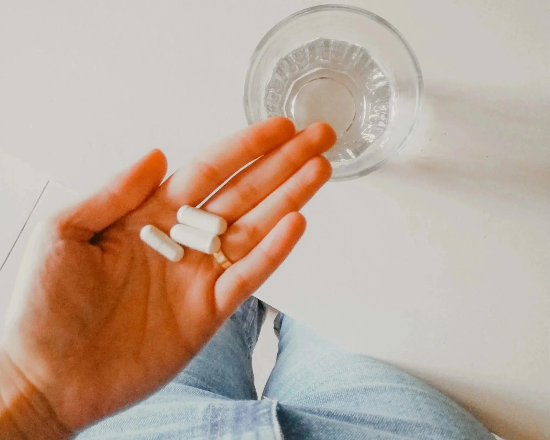 Patient holding pills as part of weight loss management plan