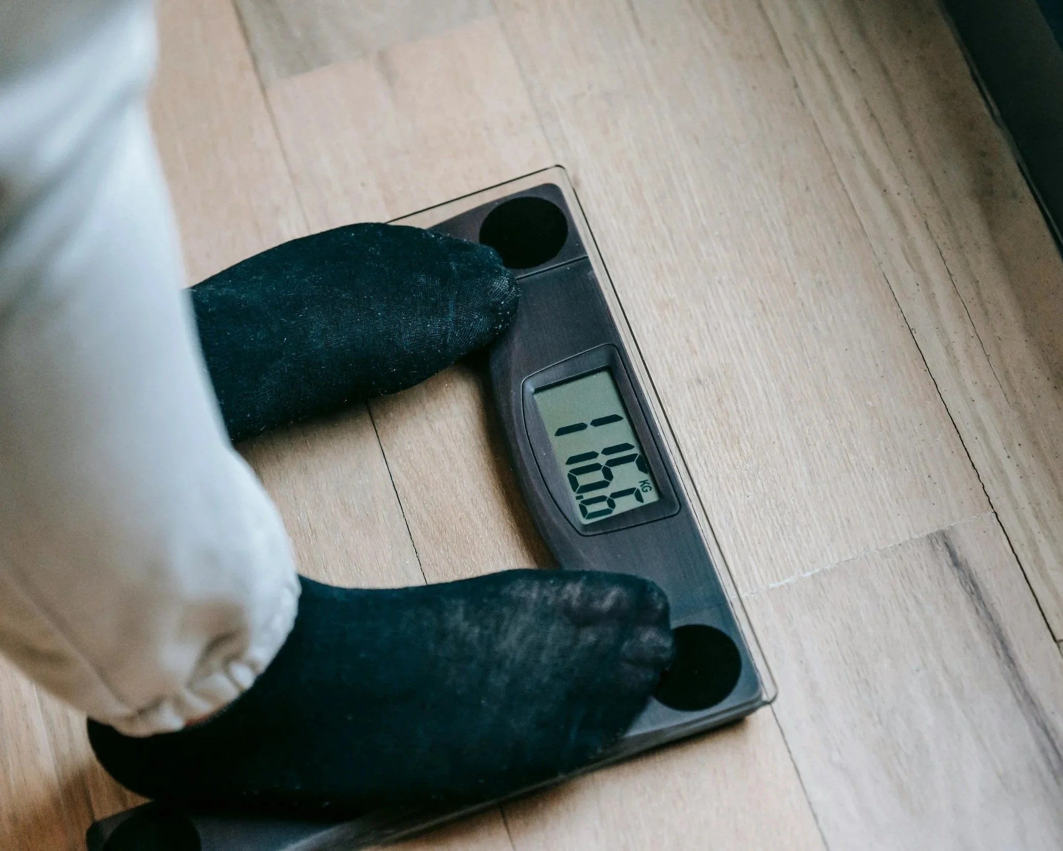 Person weighting themselves - two feet standing on scales