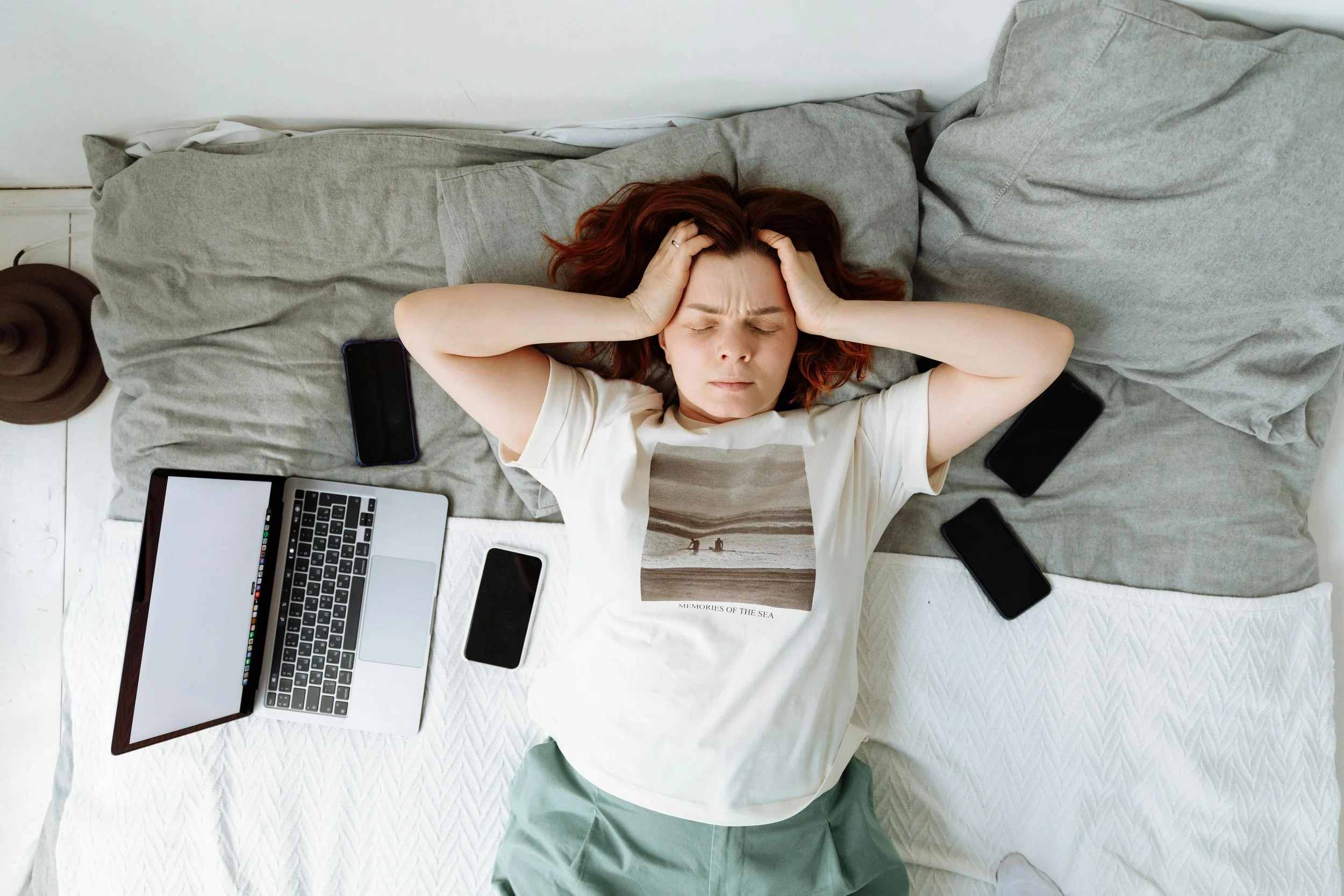 Stressed lady laying on her bed