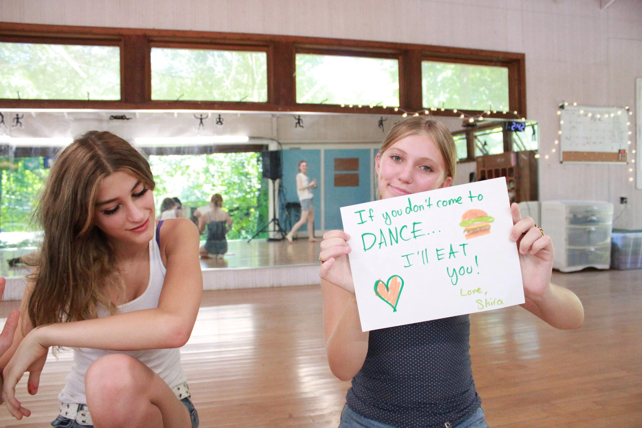 CITs make signs promoting their shops to hang around camp