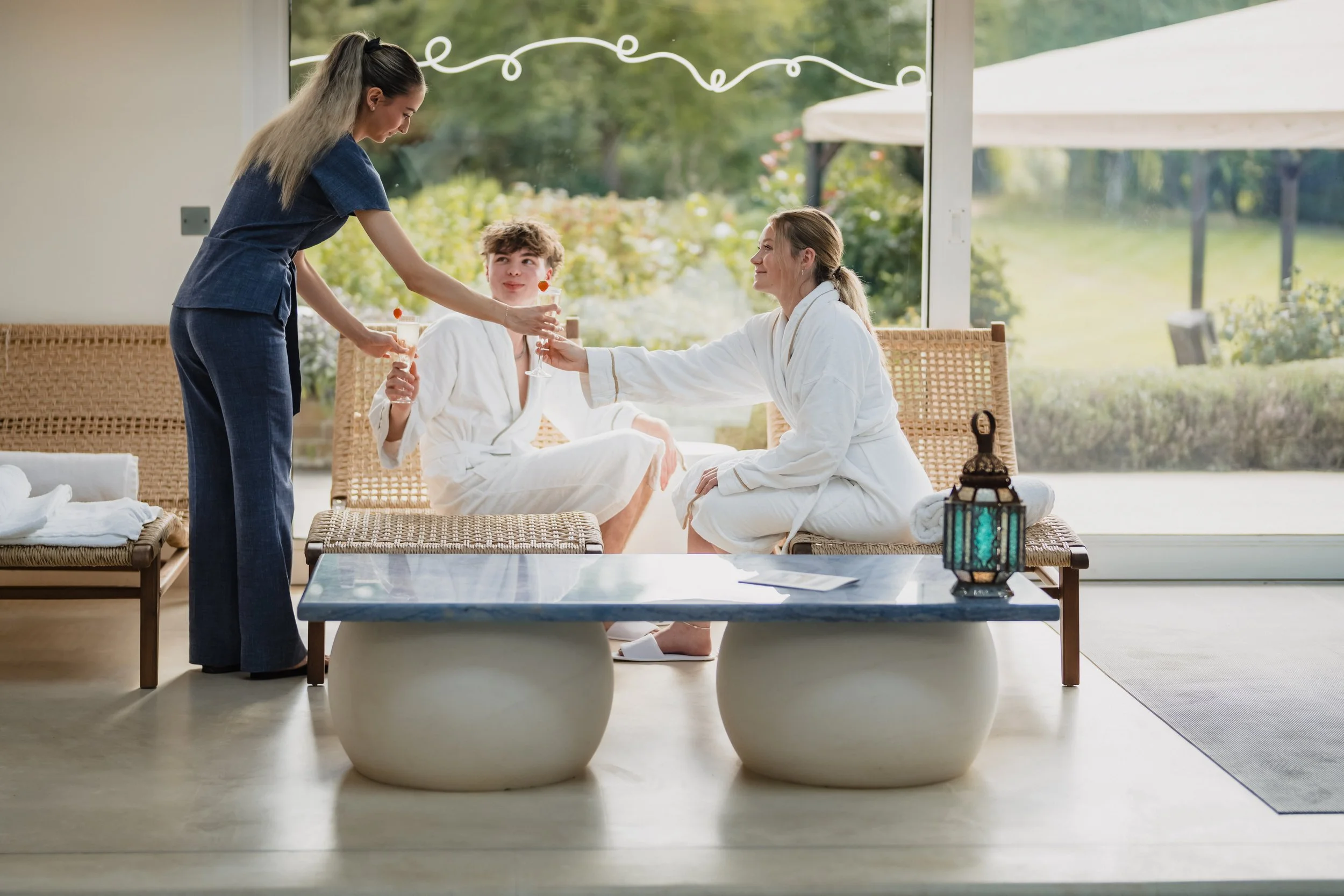 Spa day experience at Waresley Park Estate with guests served drinks in the lounge