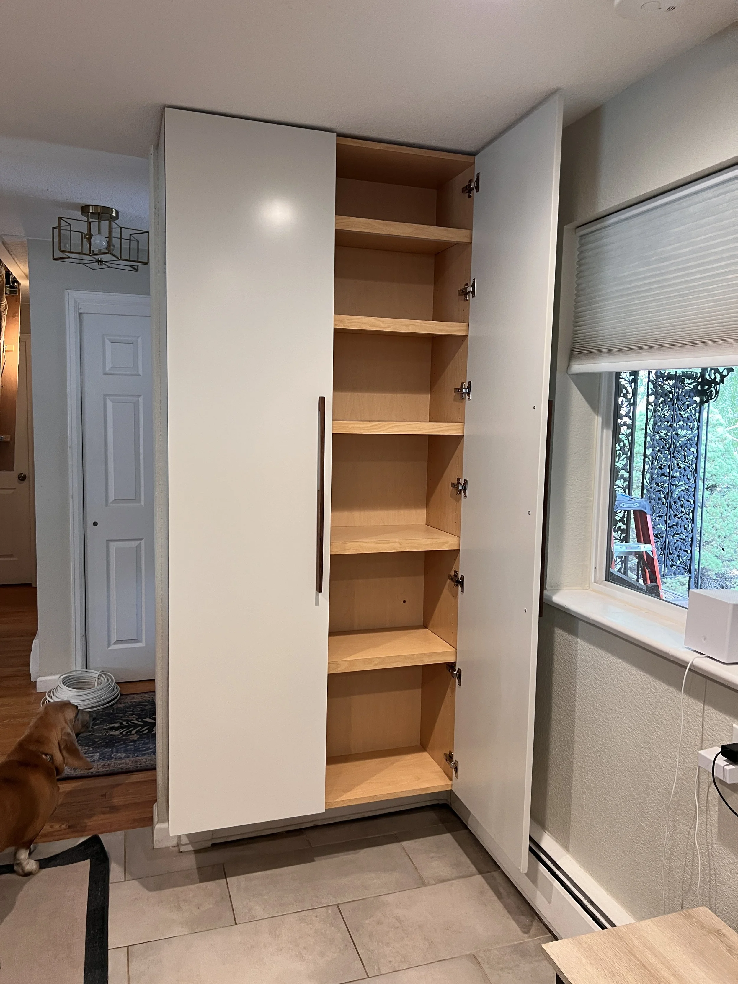A wall hanging pantry cabinet that doesn't cover the baseboard heat. 