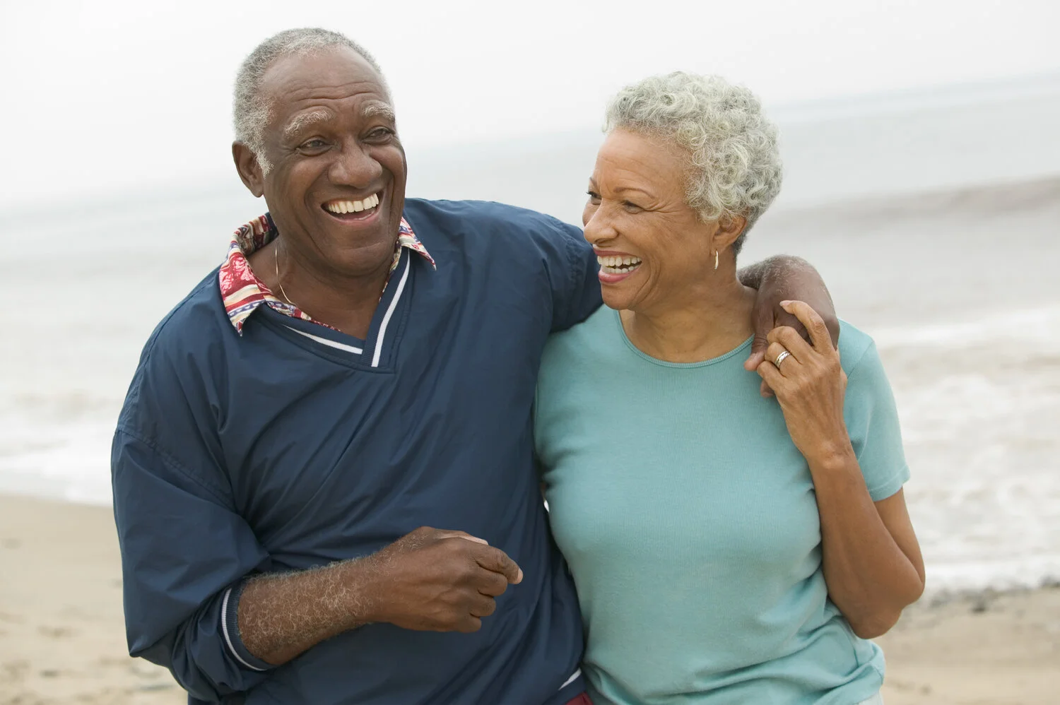 Senior+couple+embracing+at+beach+-+1876426.jpg