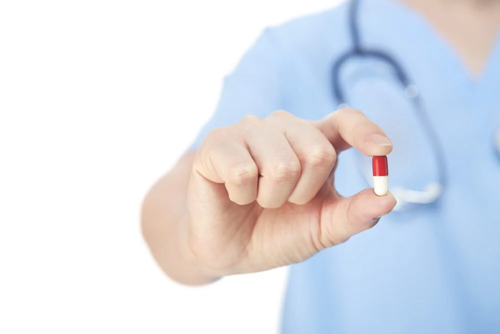 Medical+personnel+holding+a+pill+-1941404.jpg