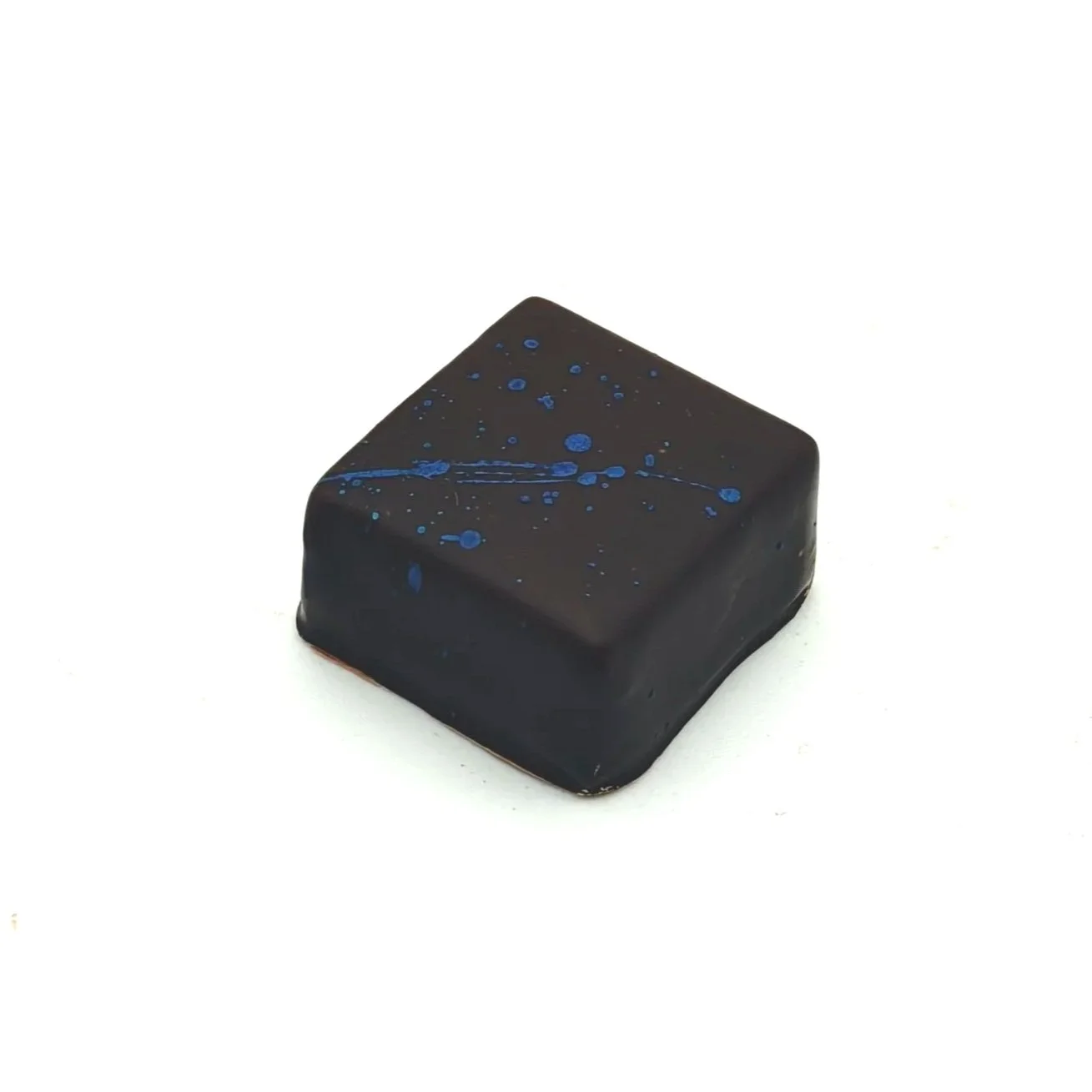 Dark chocolate square with blue splatters