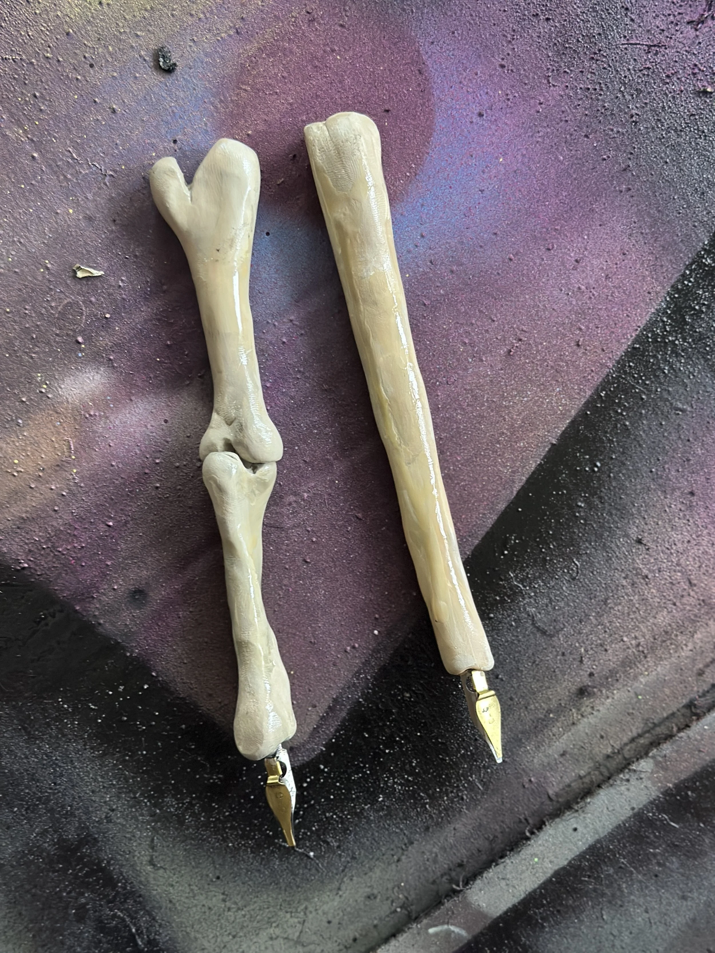 Hand sculpted bones out of polymer clay, with old nibs attached for pens; Rocky Horror, 2025, Actors Theatre of Little Rock