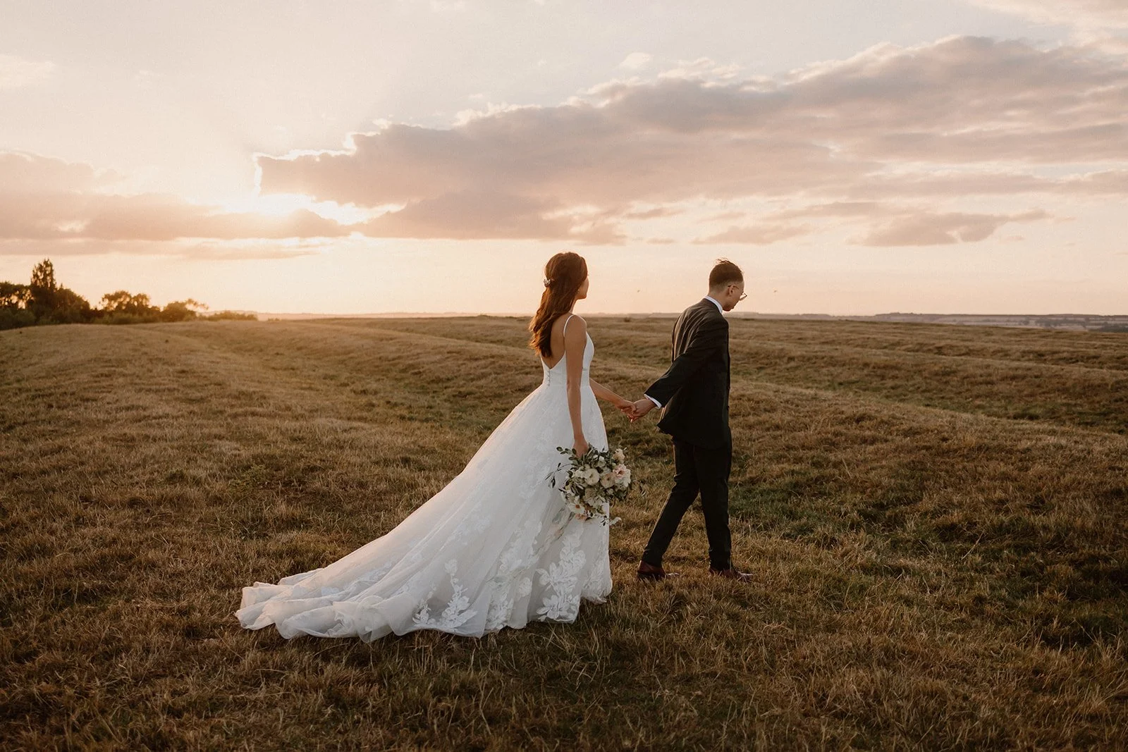 Bride and groom walking at Sunset