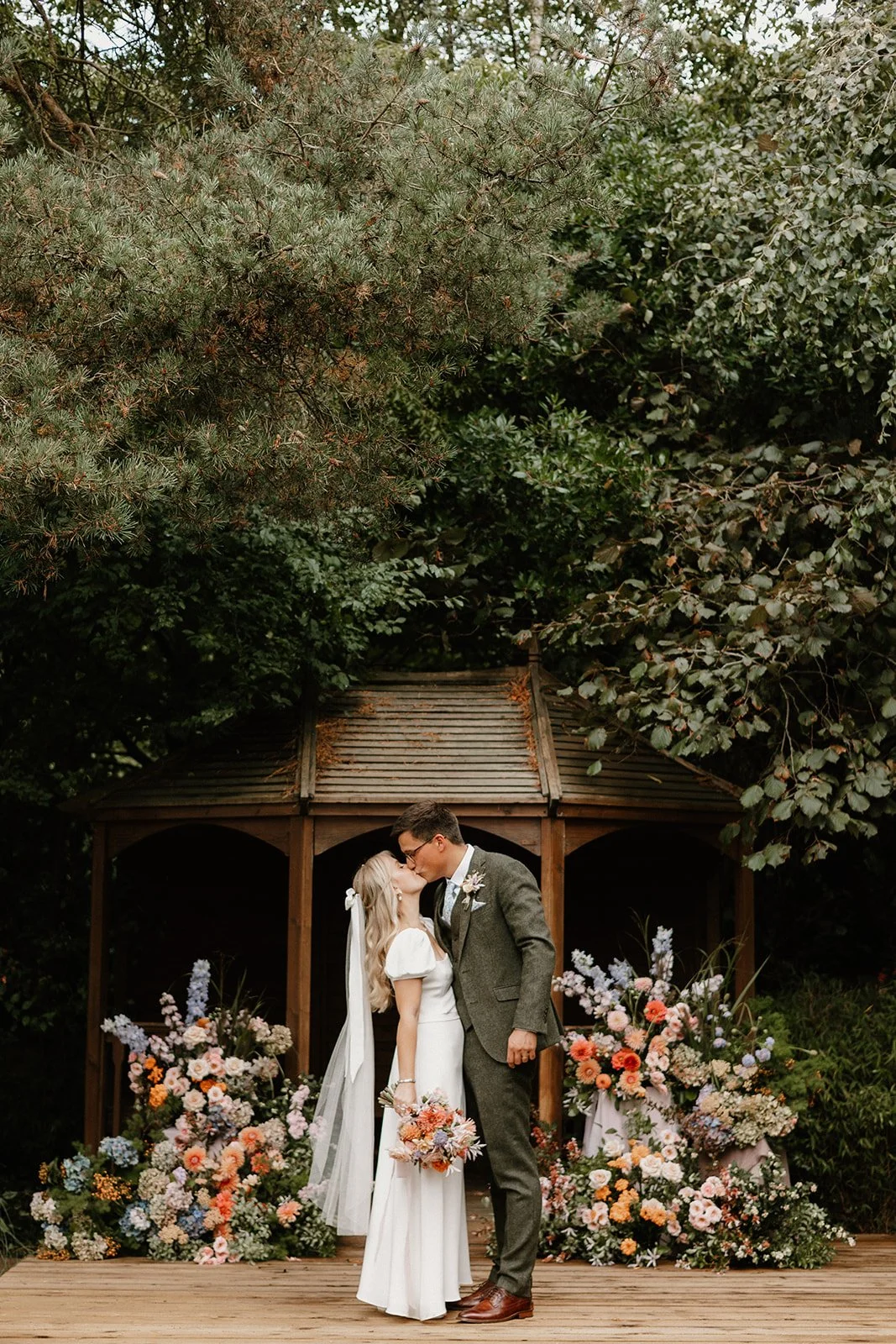 Couple kissing around flowers