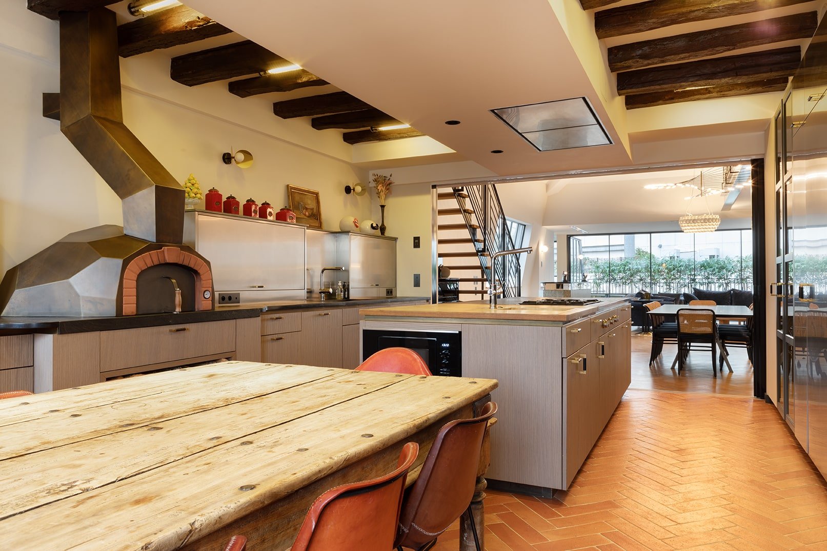 luxury penthouse rental kitchen with wood-fired pizza oven and large dining table 