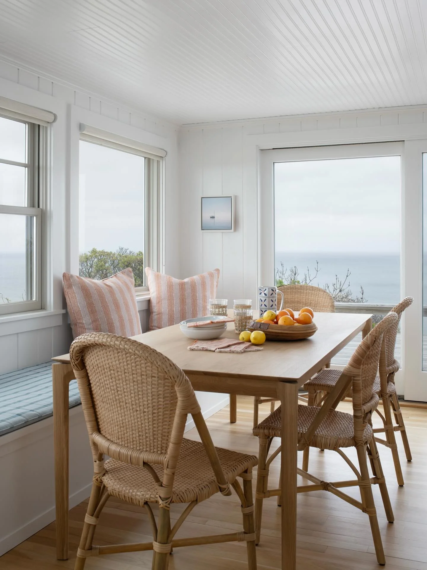 This custom banquette was designed for lingering meals and slow morning coffee&mdash;overlooking the beauty of Cape Cod Bay. Cozy, coastal, and completely custom.

Would you ever want to leave this seat?

. . . 

Design &amp; Styling: @houseofcocoint