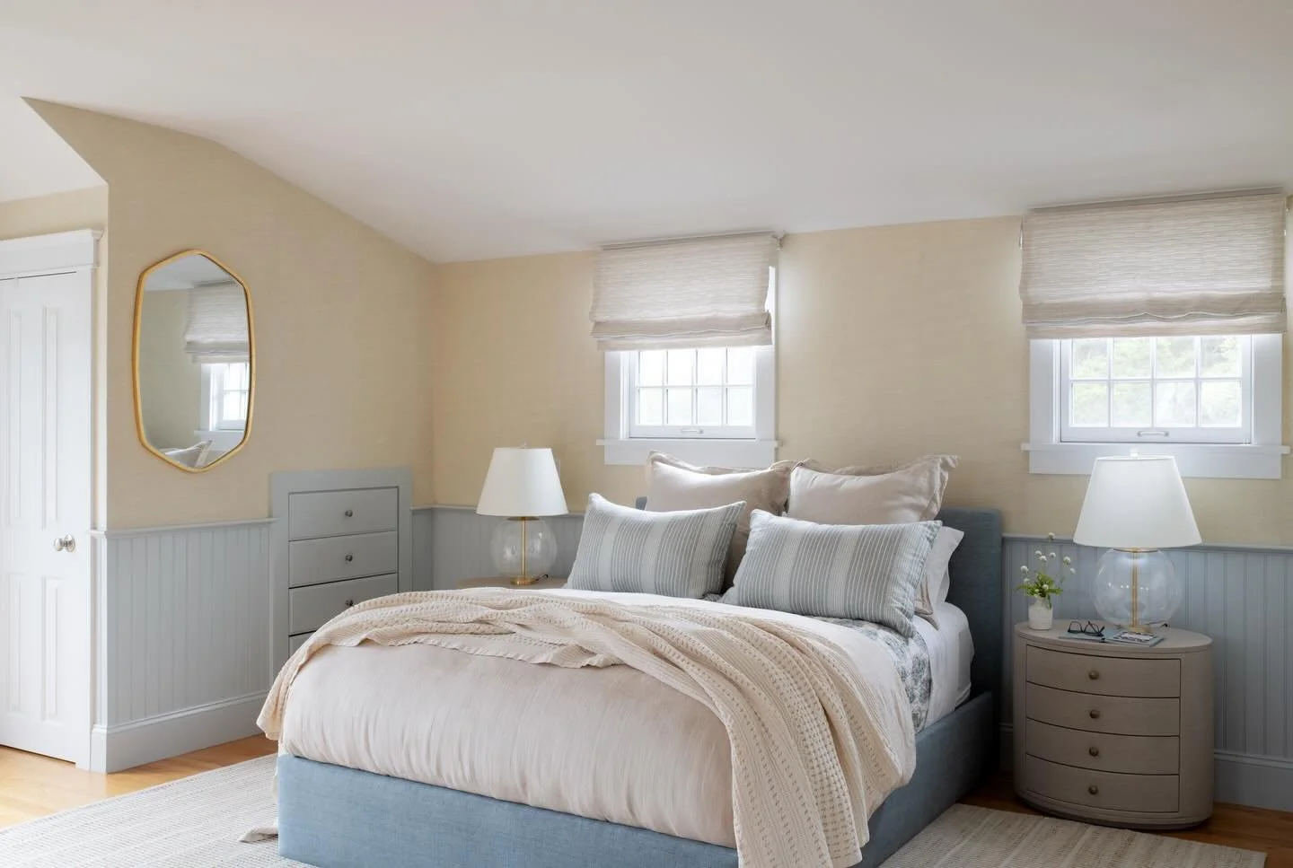 A seaside primary bedroom layered in grass-cloth wallpaper and soothing hues. Designed for slow mornings and peaceful evenings. #BacktothebeachProject 

. . . 

Interior Design + Styling: @houseofcocointeriors 
Photography: @jessicadelaneyphotography