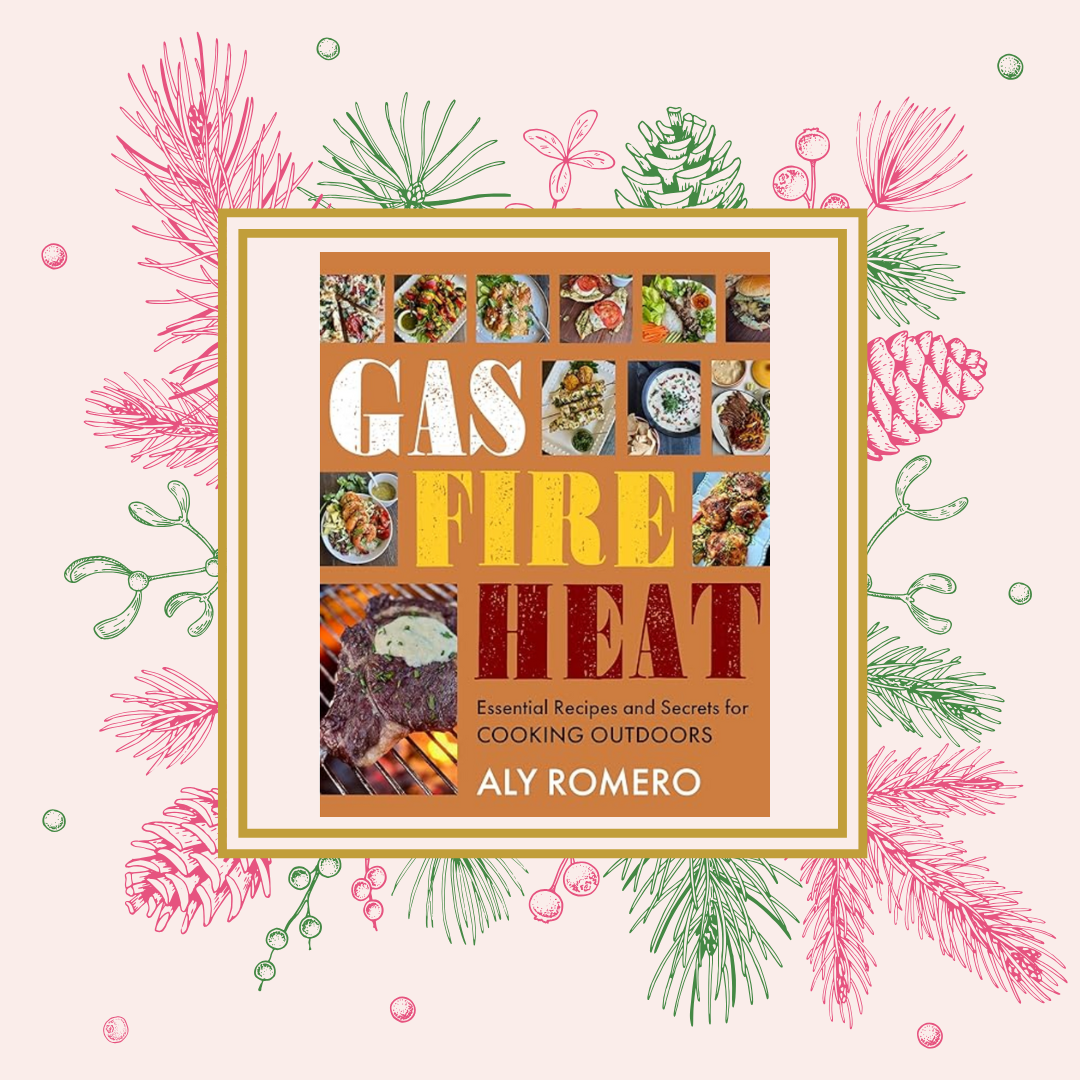 Cover of a cookbook titled 'Gas, Fire, Heat' by Aly Romero, featuring images of outdoor grilled and cooked foods, including steaks and various dishes, with a background of pink and green holiday-themed pine and berry illustrations.