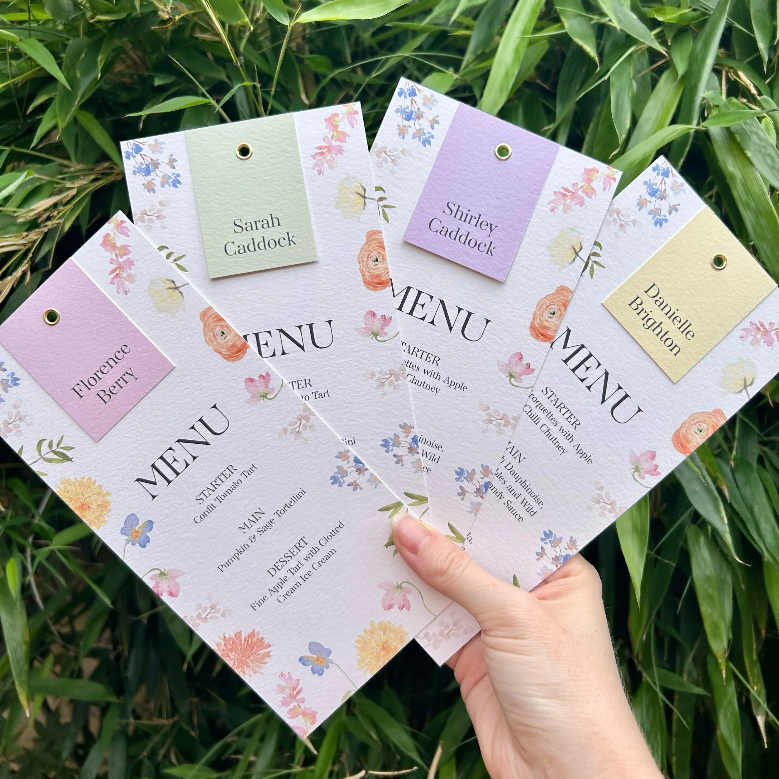Floral pastel colour personalised wedding menus with name tags