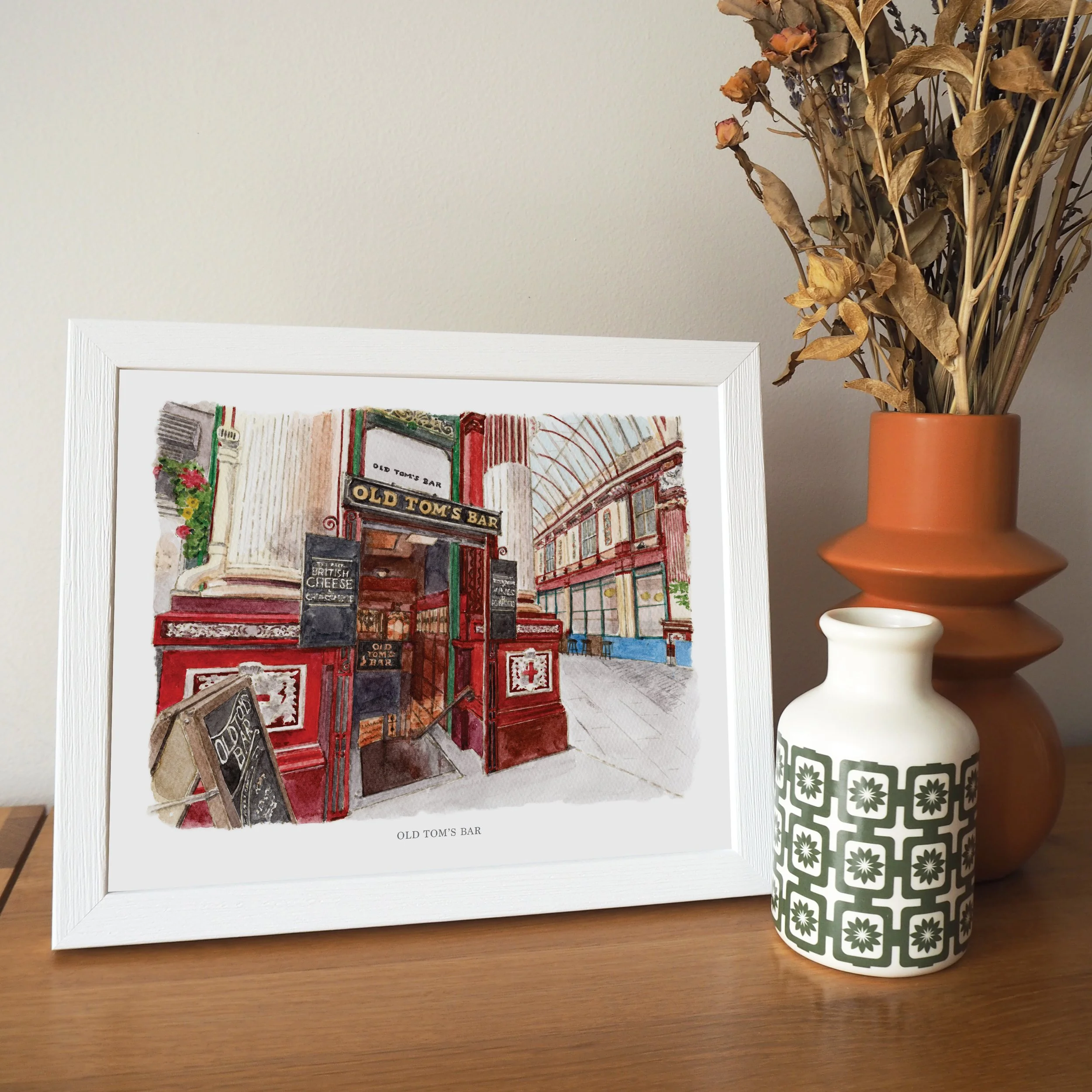 A framed personalised print of a watercolour illustration of Old Tom's Bar, Leadenhall Market, London