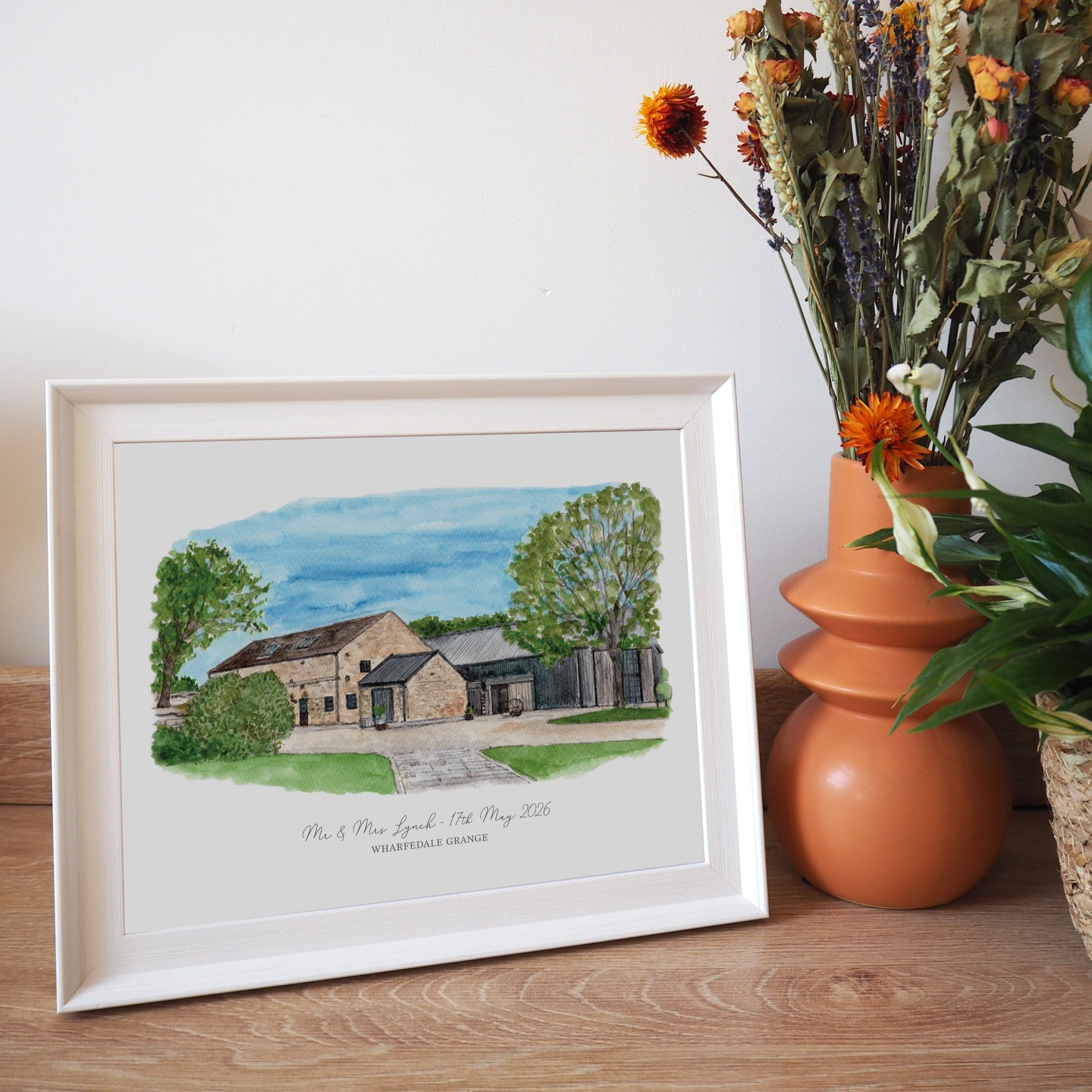A framed personalised print of a watercolour illustration of wedding venue Wharfedale Grange