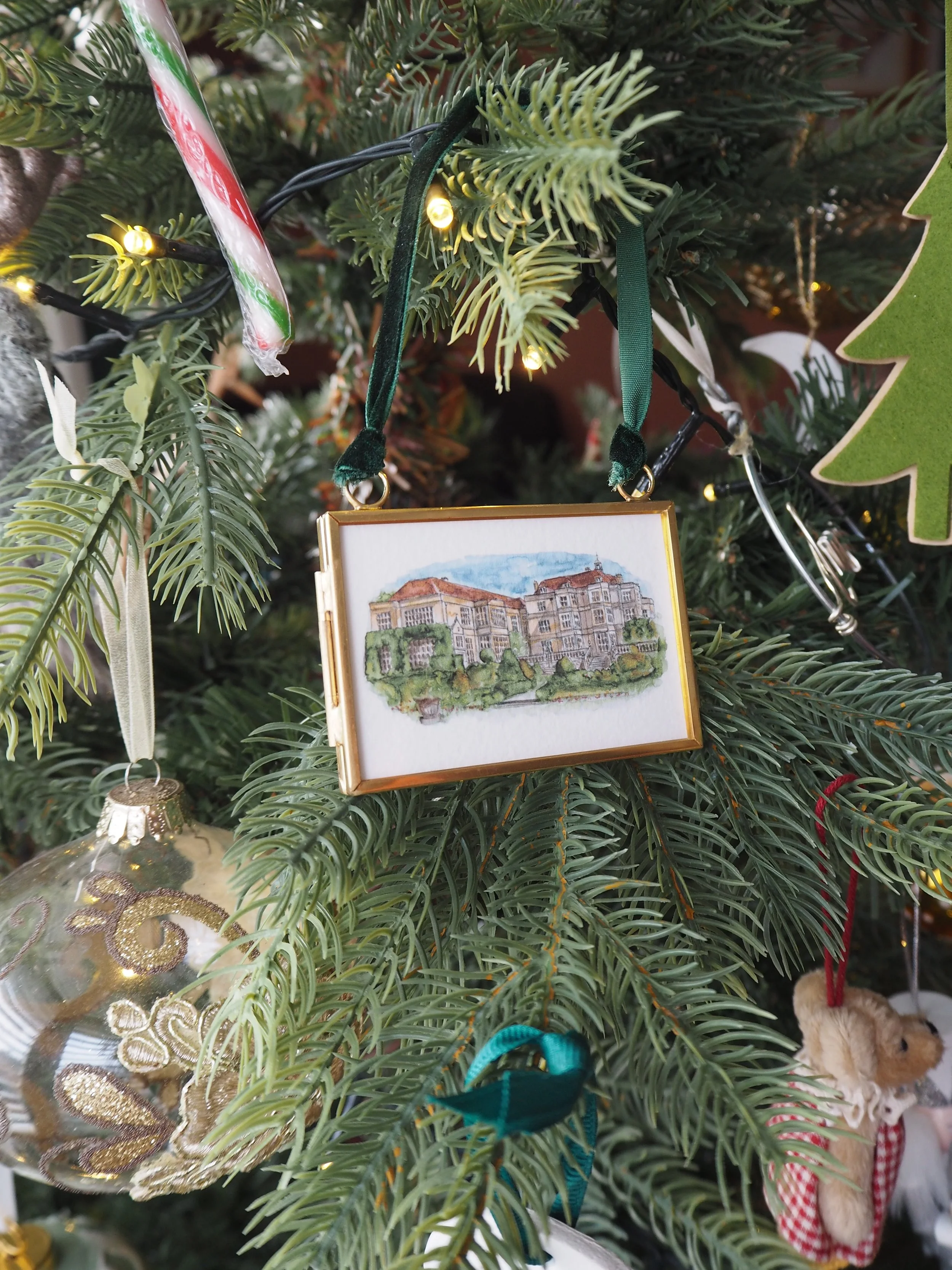 a small hanging frame christmas tree decoration featuring a watercolour illustration of Fanhams Hall