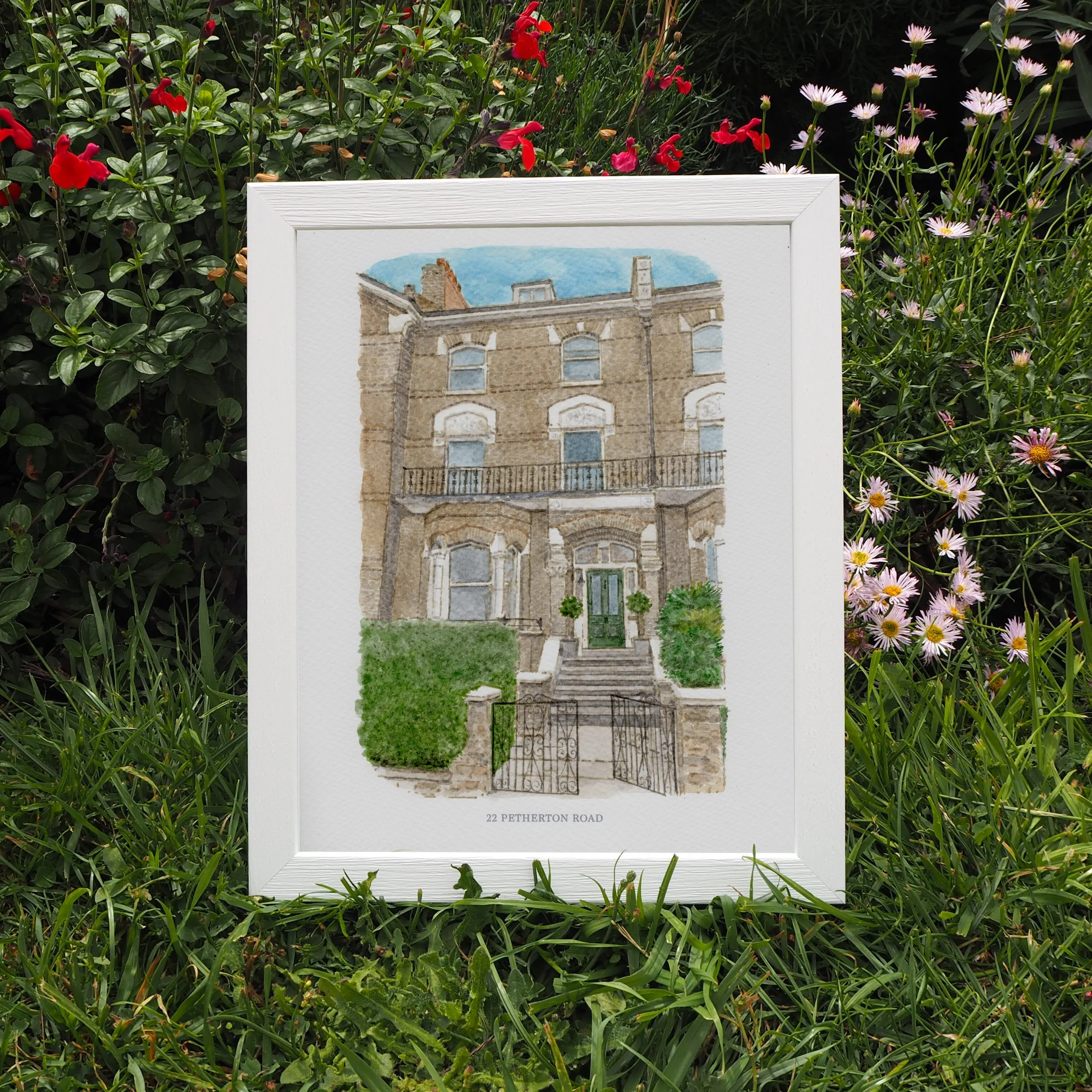 A framed house portrait of a london townhouse with a green front door