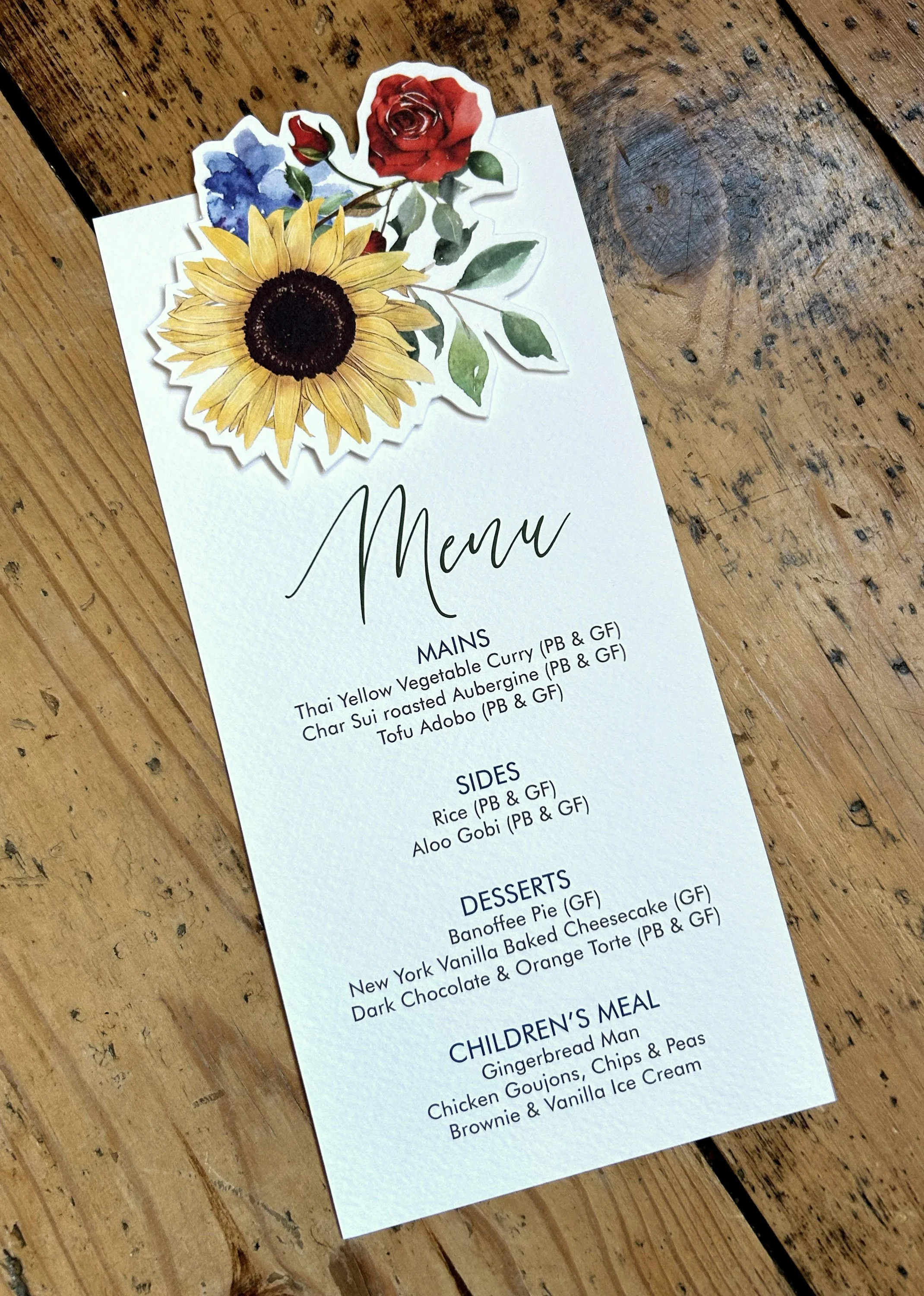 A wedding menu featuring die-cut flowers