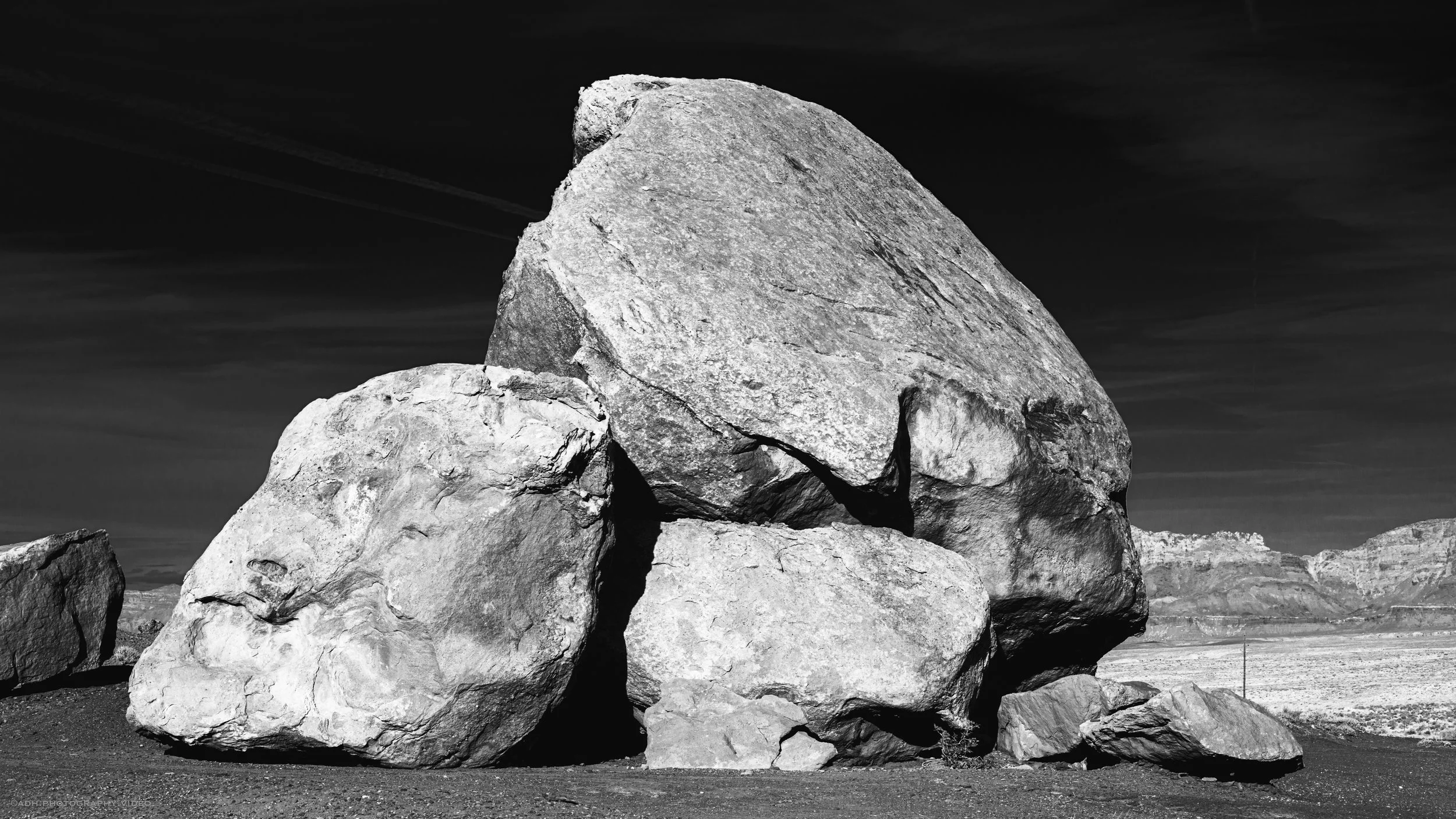 black and white photo of large boulders in sun