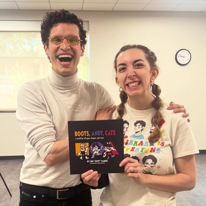 Photo: Skippy with Carly from Bondurant Public Library. The library purchased a copy of Skippy's children’s book “Boots, Andy, Cats: a world for all ages, shapes, and sizes.” (2026)