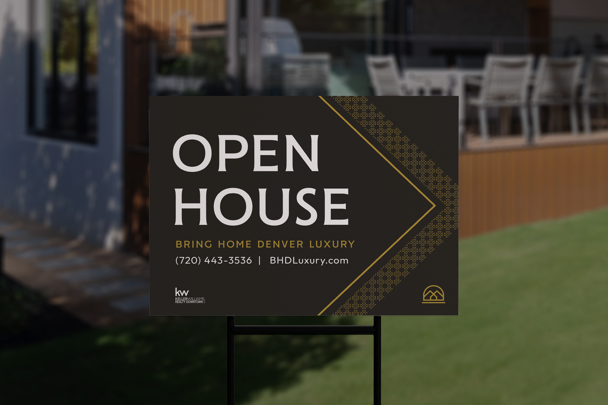 A sign outdoors announcing an open house for a luxury property in Denver, with contact details and a logo.