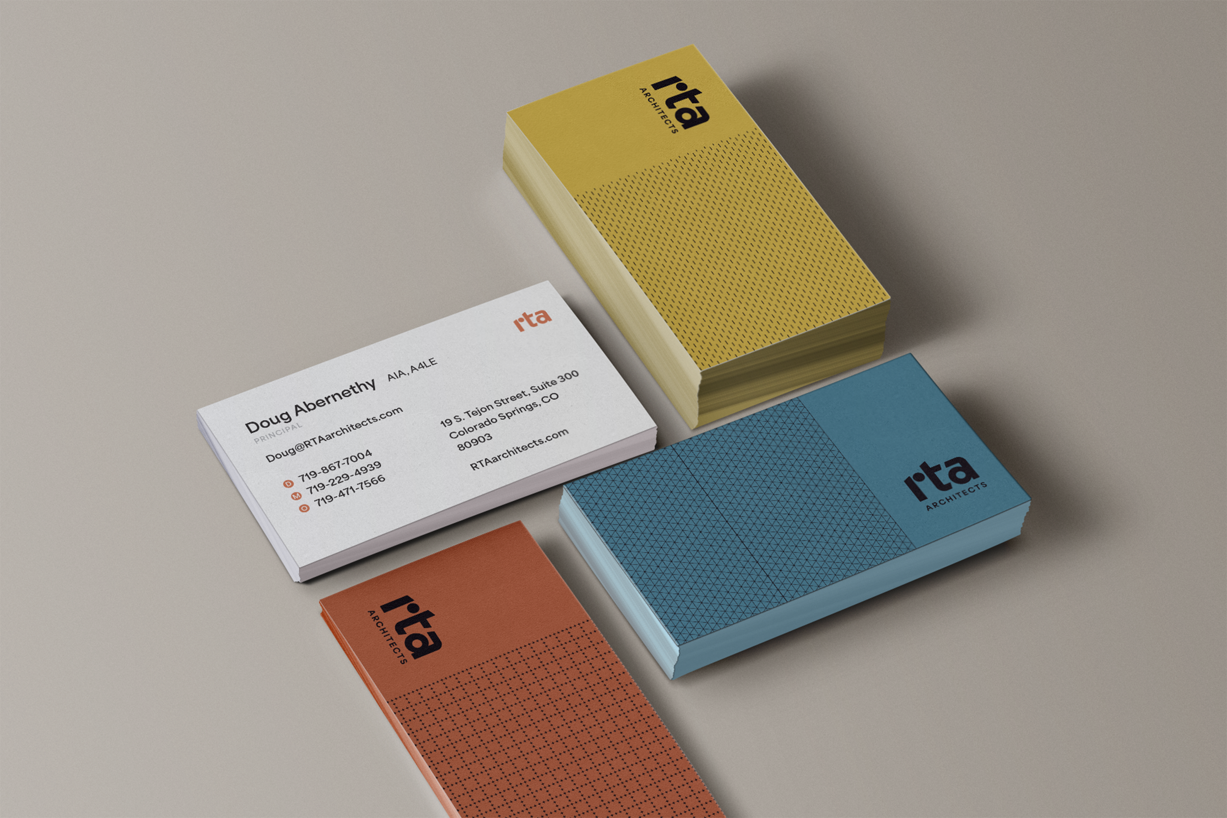 Business cards and notepad for rta Architects on a neutral surface.