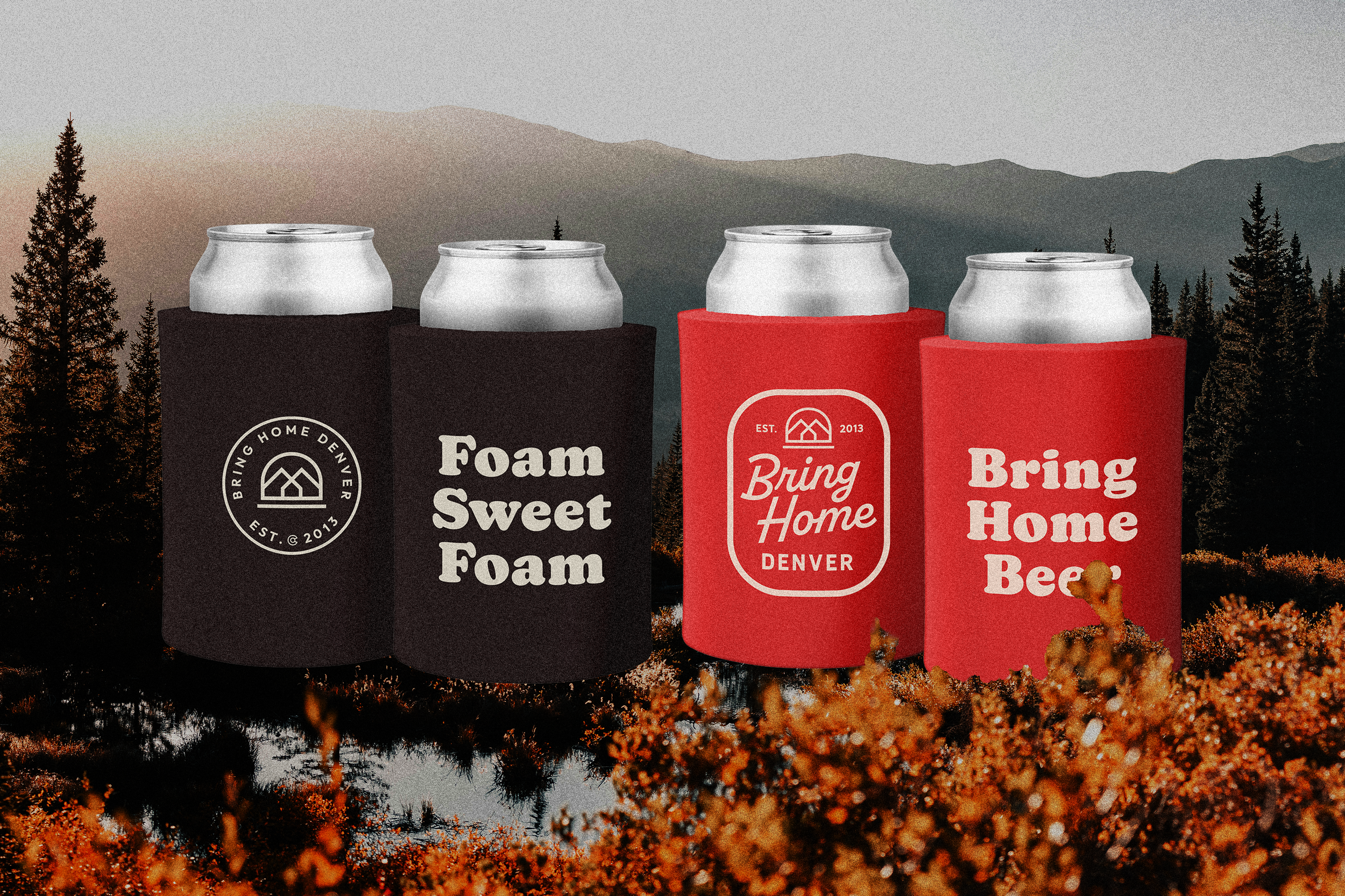 Four beverage cans with unique can koozies, two black and two red, set against a mountain landscape with trees. The cans on the left have the logo "Bring Home Denver" with a mountain image, and the black cans read "Foam Sweet Foam." The red cans read "Bring Home" and "Bring Home Beer."