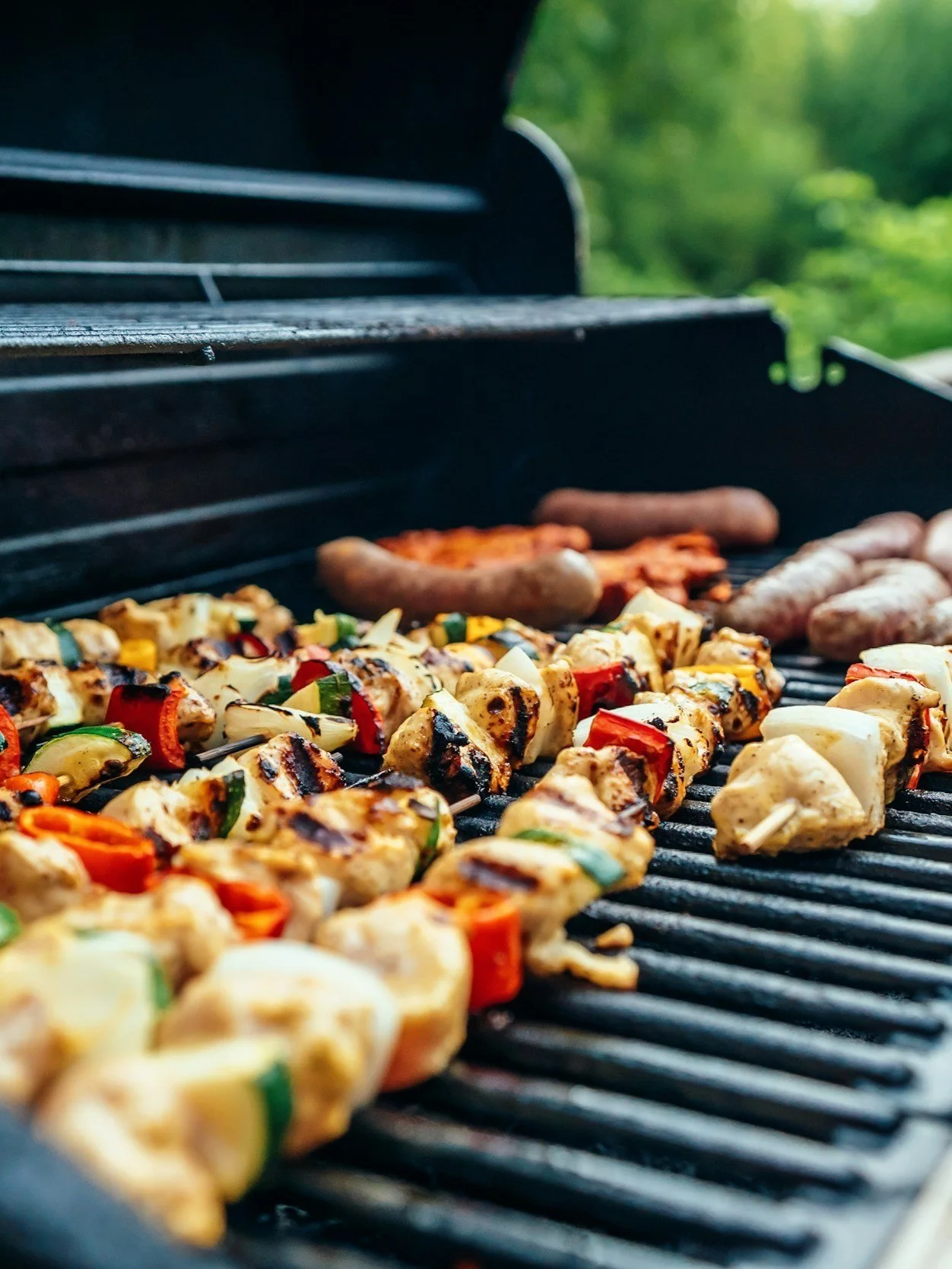 Grilled skewers with vegetables and meat on barbecue grill