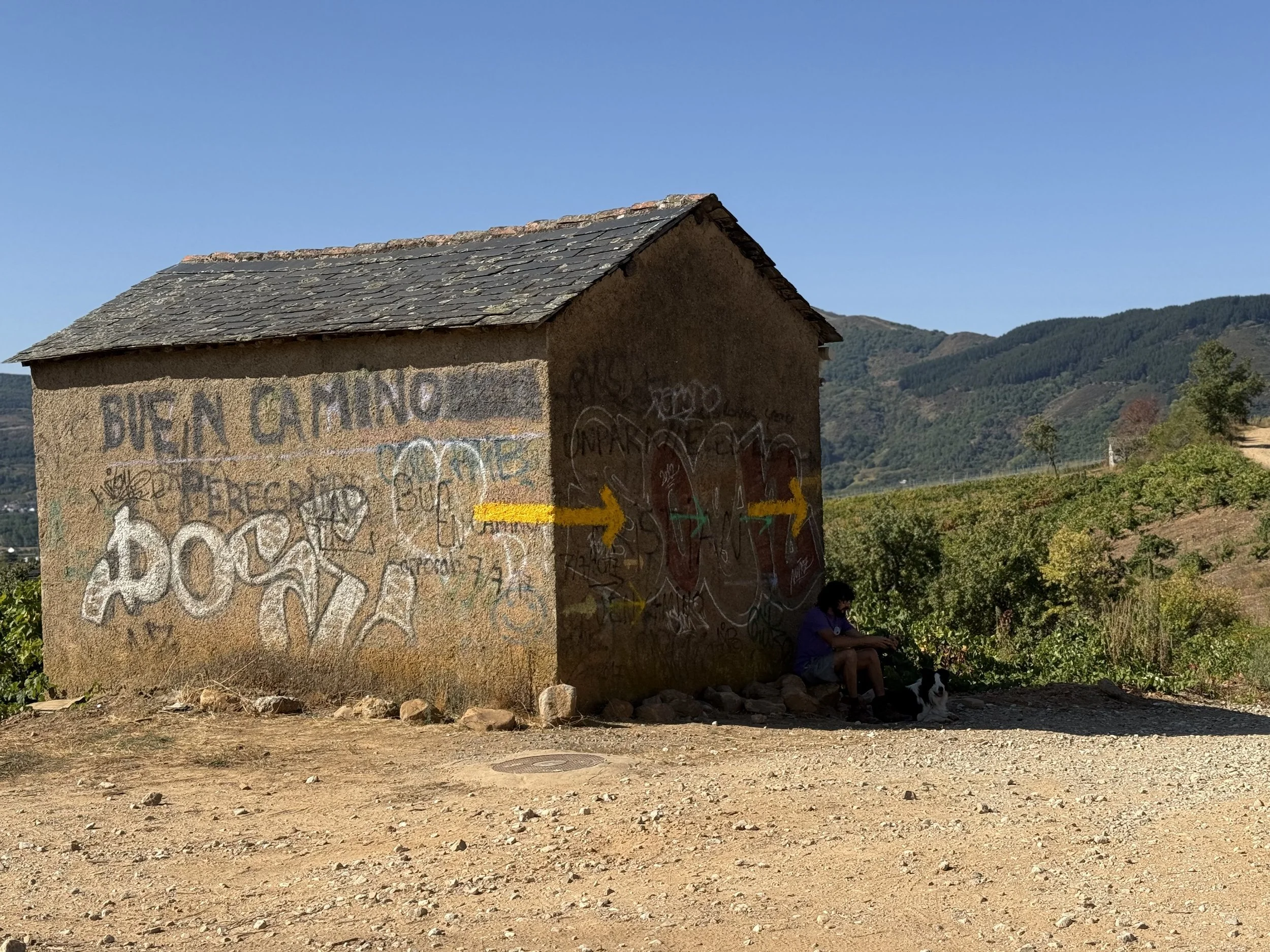 buen camino signage on abandoned building