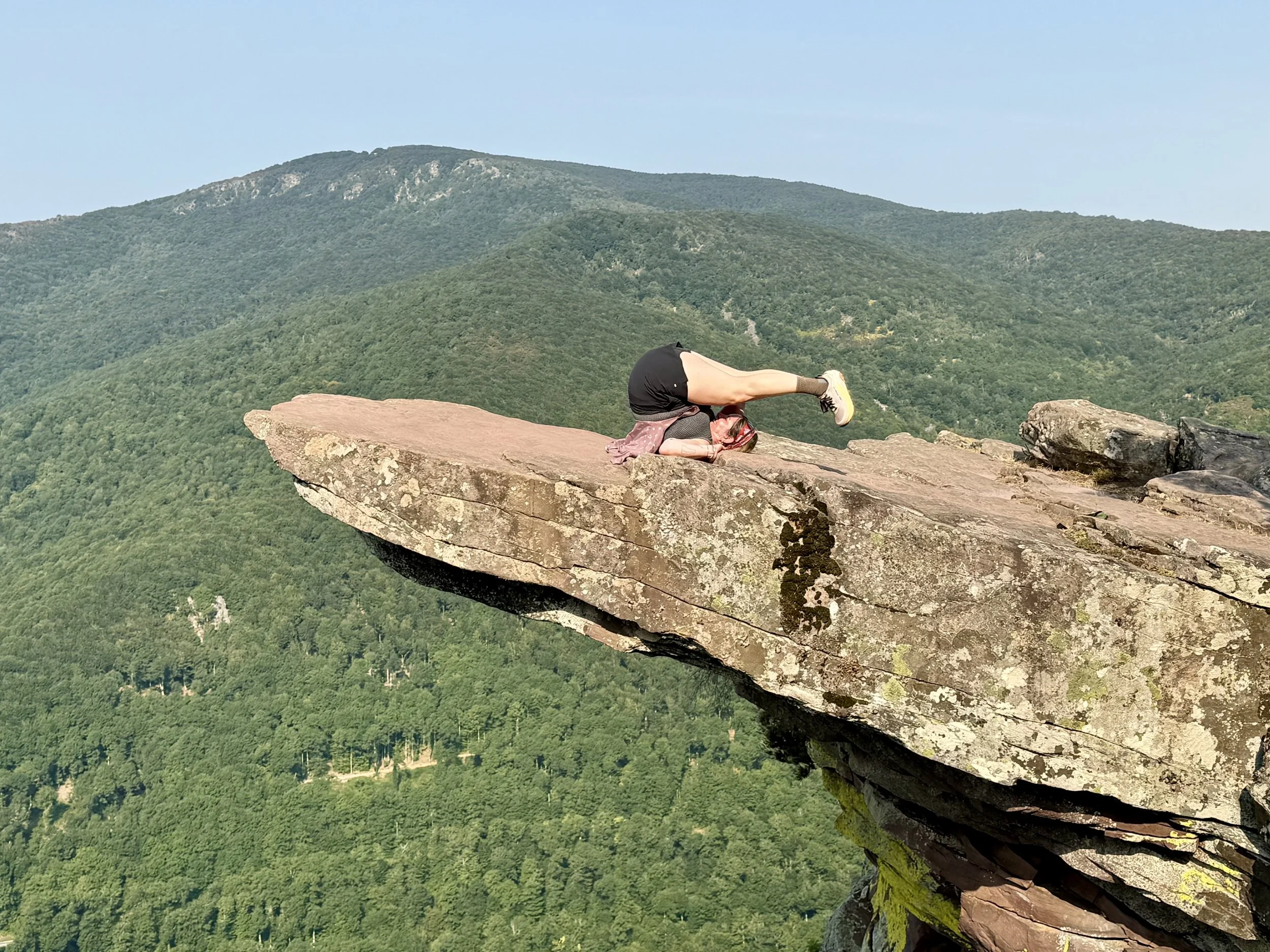 Stretching on a cliff hanging rock