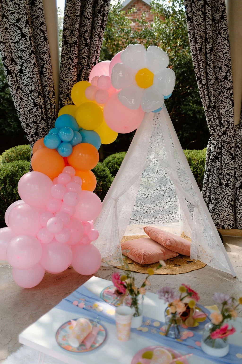 Colorful balloon garland added to a Wanderlust Picnics event design