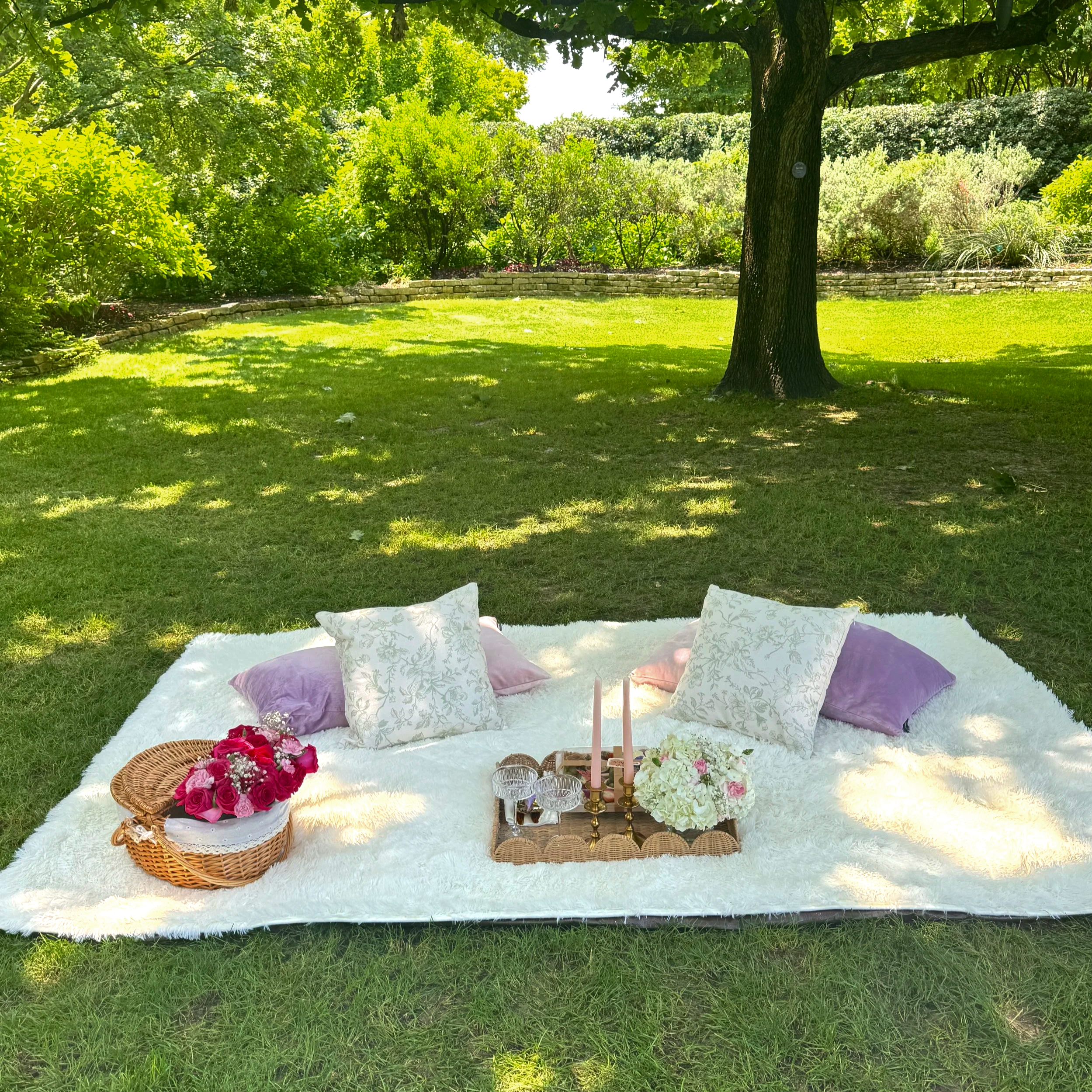 White picnic blanket with luxury floral decor in Dallas, TX, styled by Wanderlust PIcnics