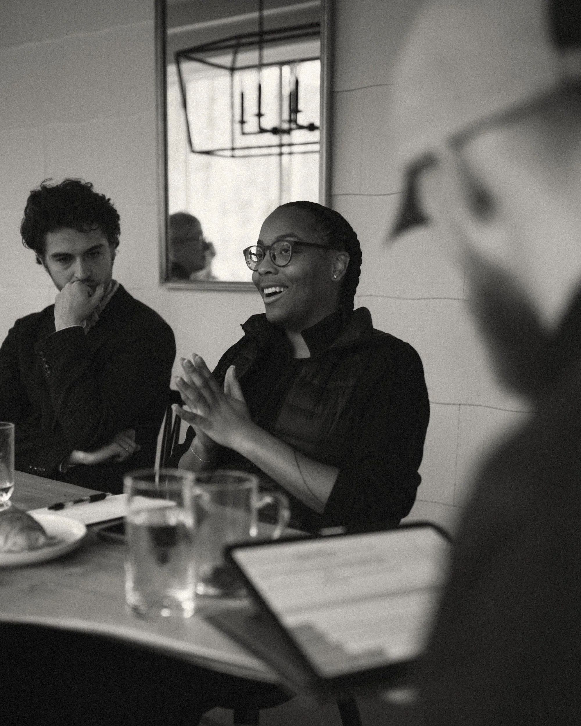A GWG faculty member laughing during a lively retreat workshop discussion.