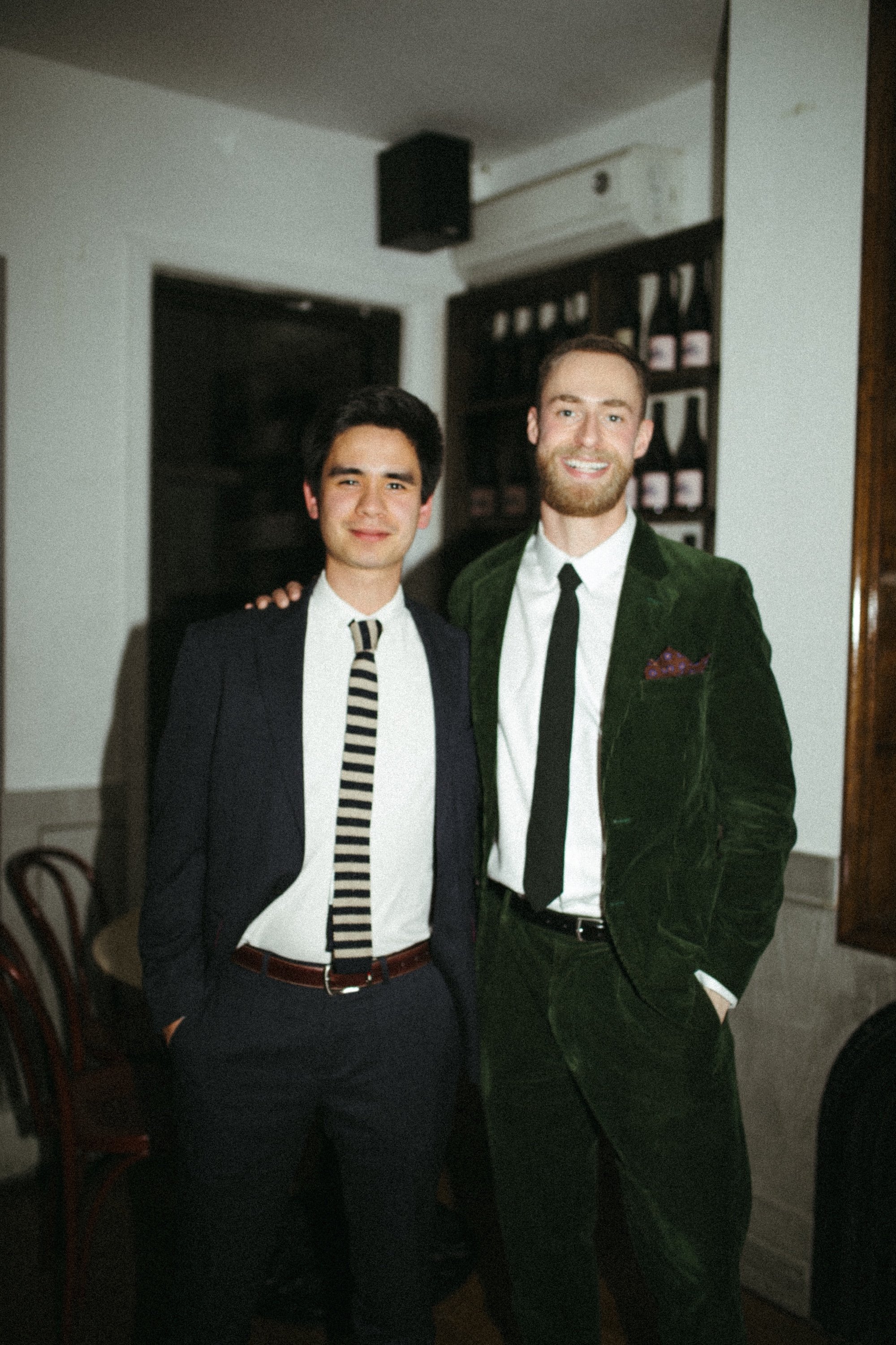Brady Gilliam and a guest literary agent in tailored suits at an evening gathering.