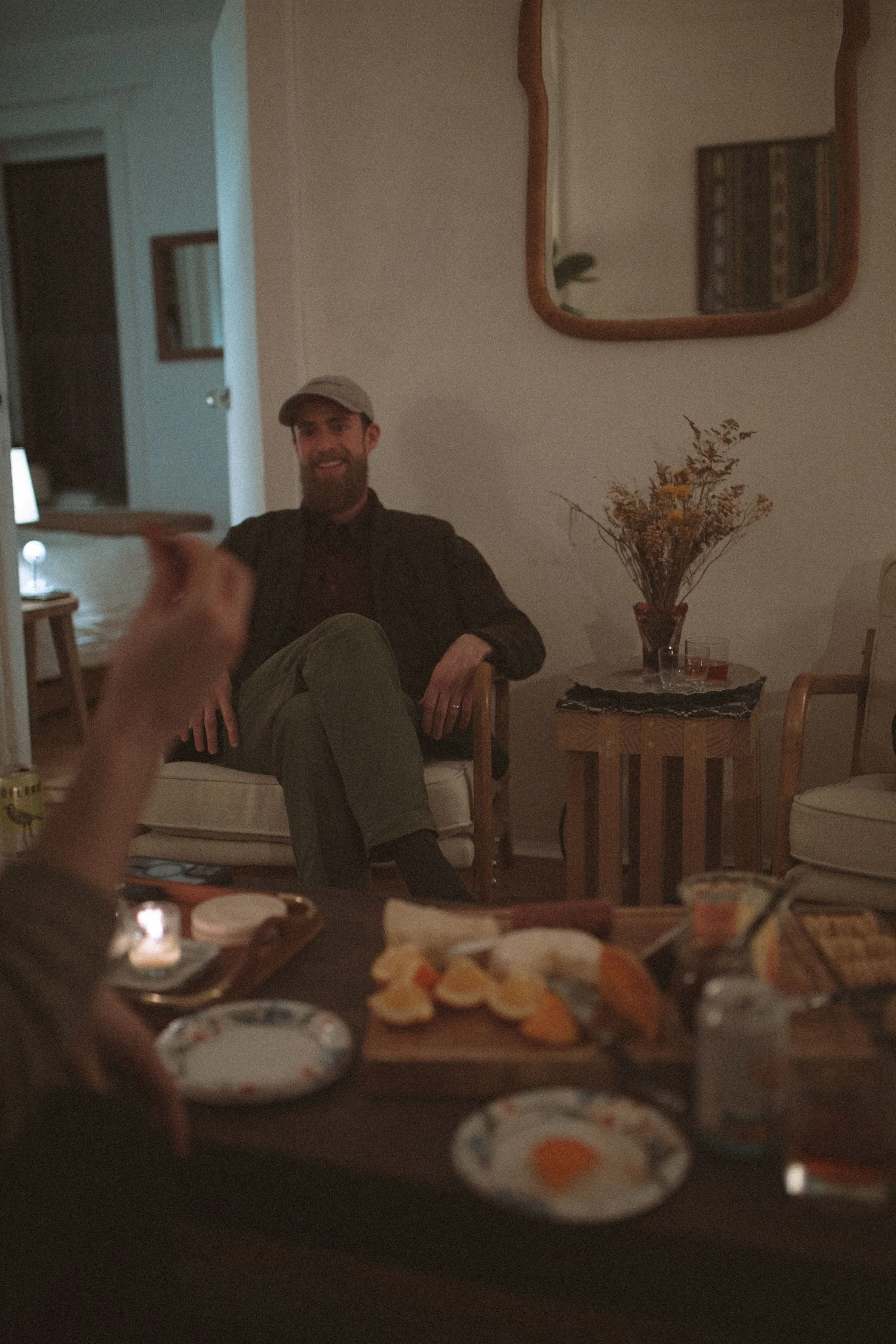 Brady Gilliam smiling across a table of snacks during a relaxed GWG community gathering.