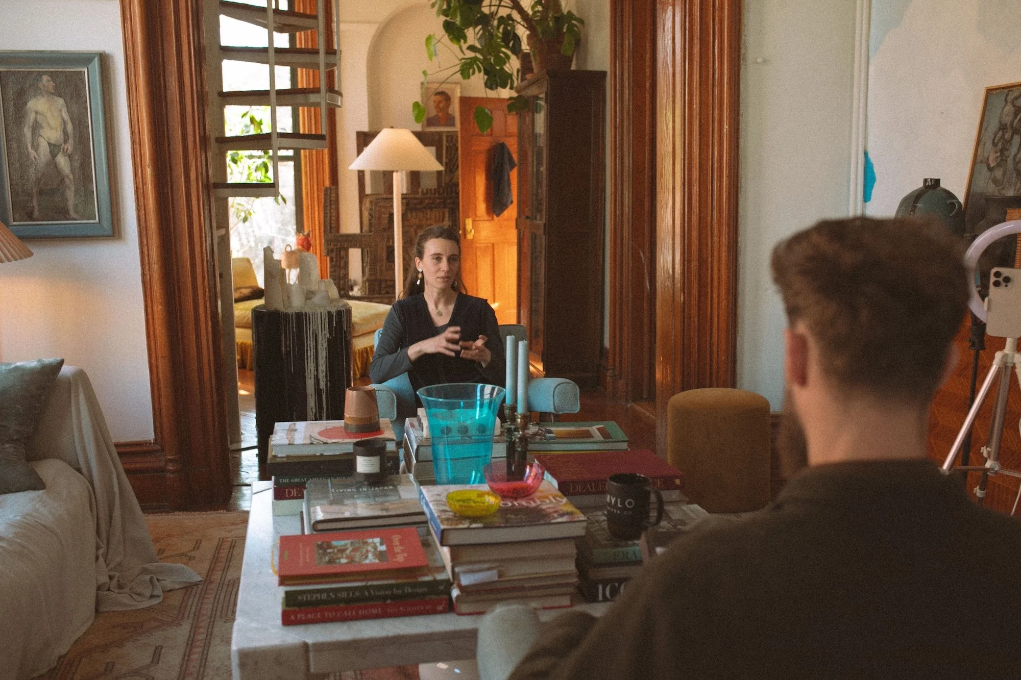 A faculty member speaking during an on-camera interview at home.