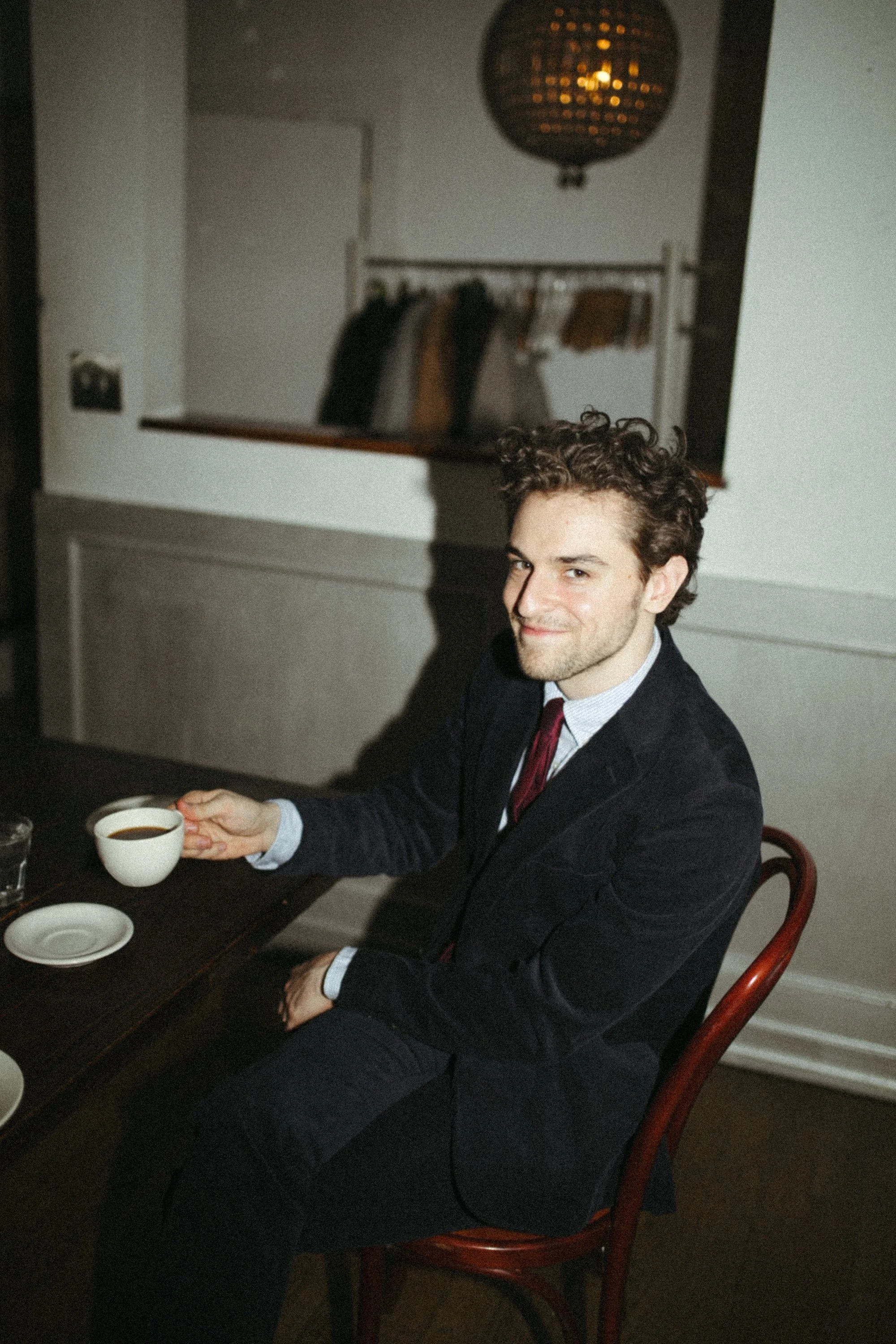 A Gilliam writing coach smiling over an espresso at the evening dinner.