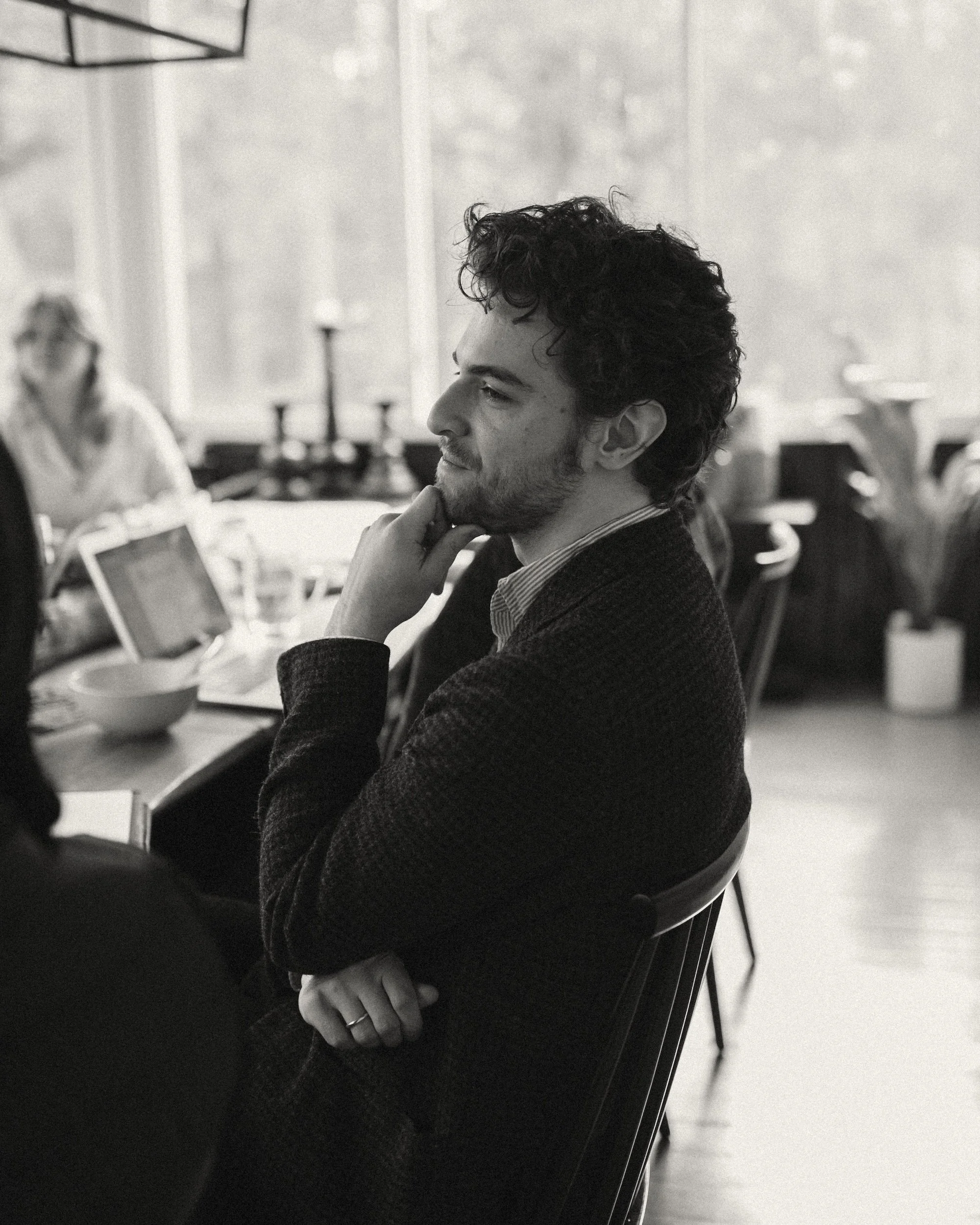 A GWG faculty member listening thoughtfully during a daytime retreat session.