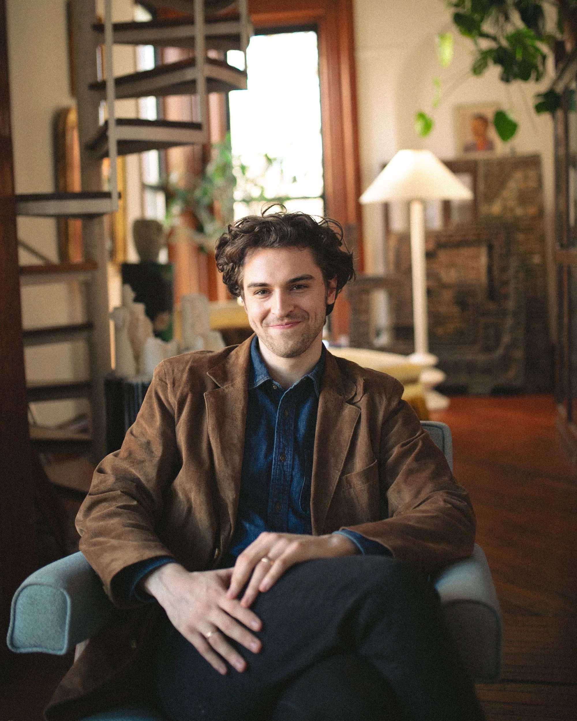 A Gilliam Writers Group faculty member's warm seated portrait.