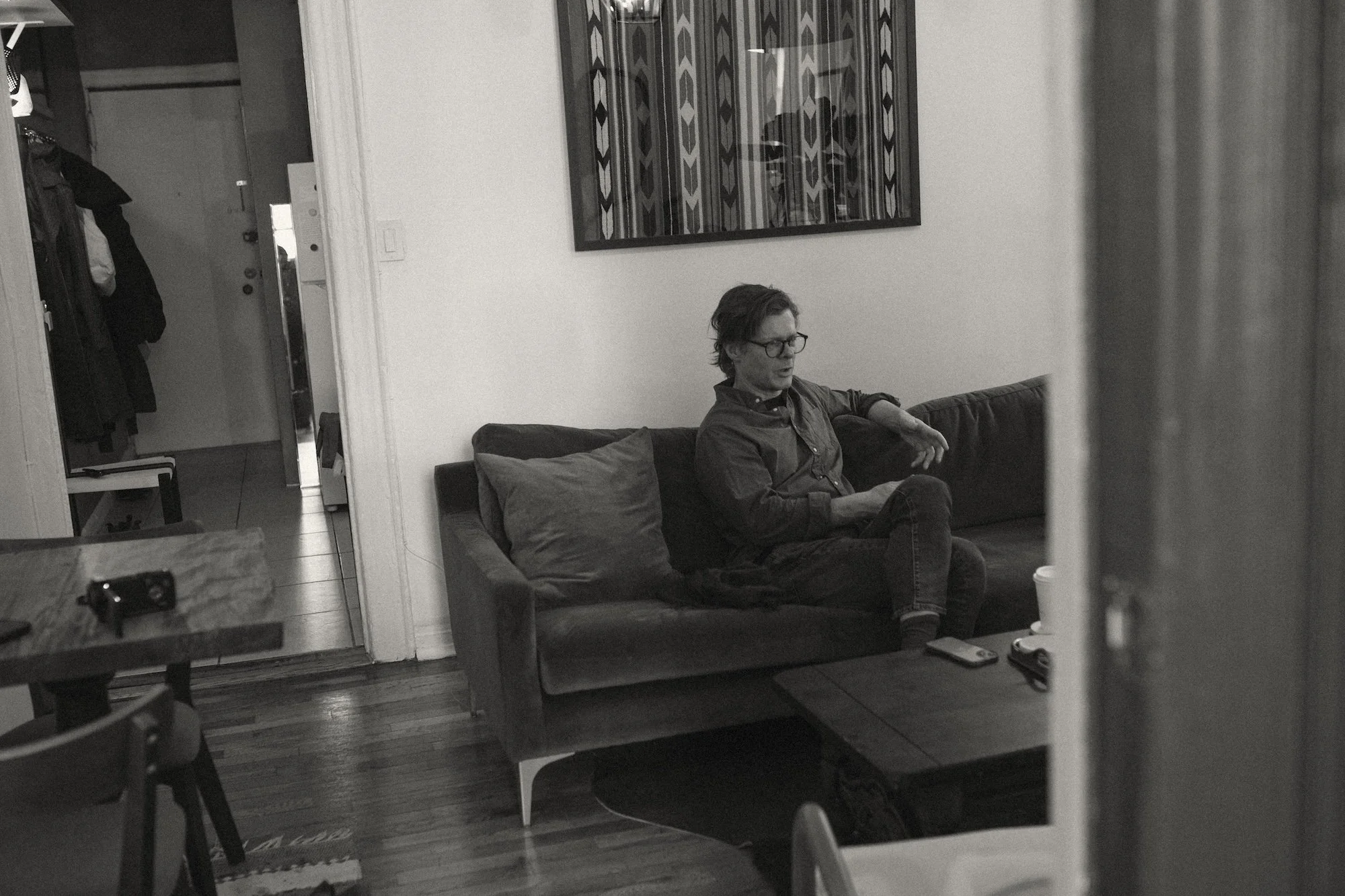 A Gilliam Writers Group faculty member talking on a couch during an interview.
