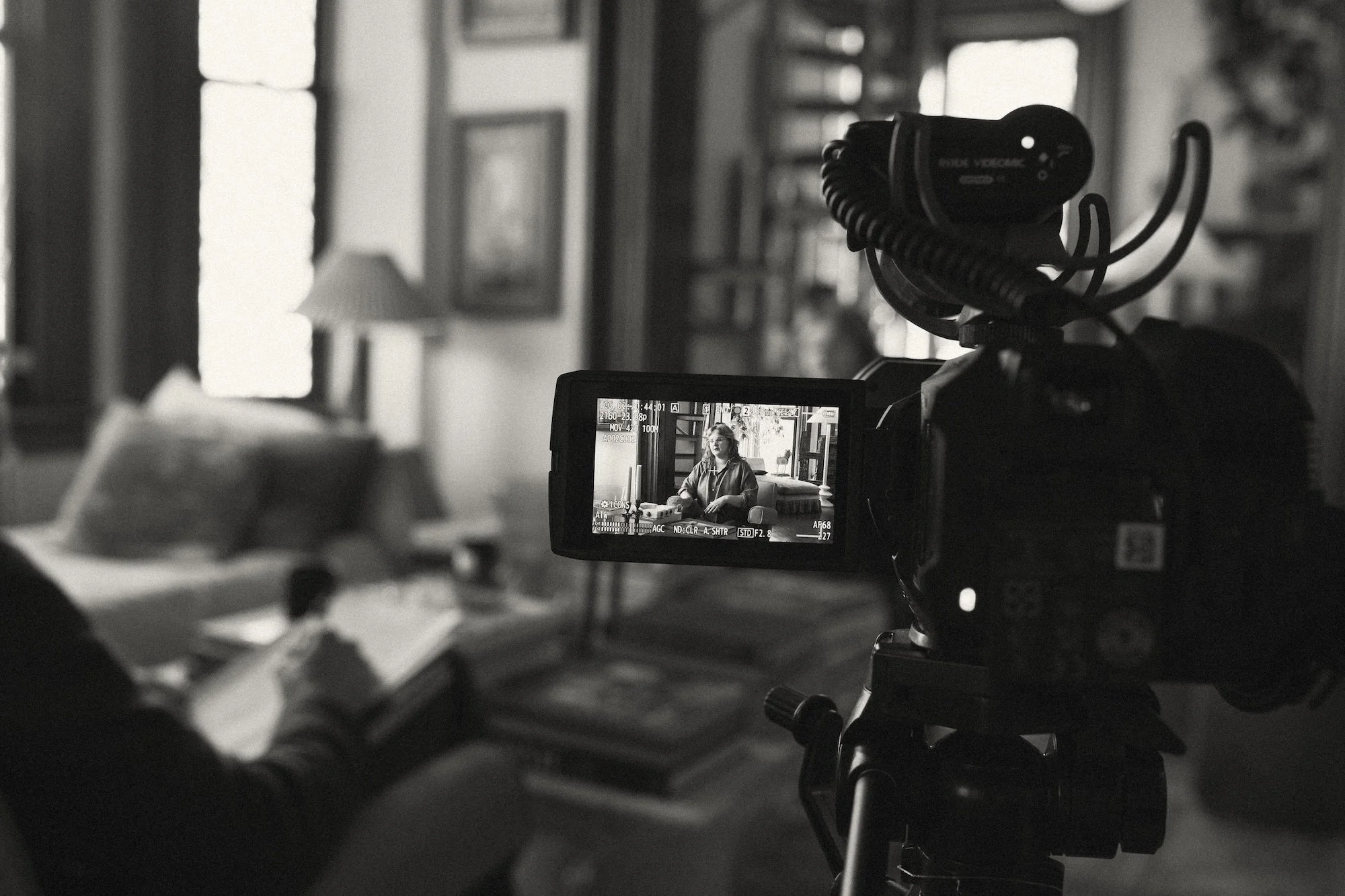 A faculty interview framed on a video camera's screen during filming.