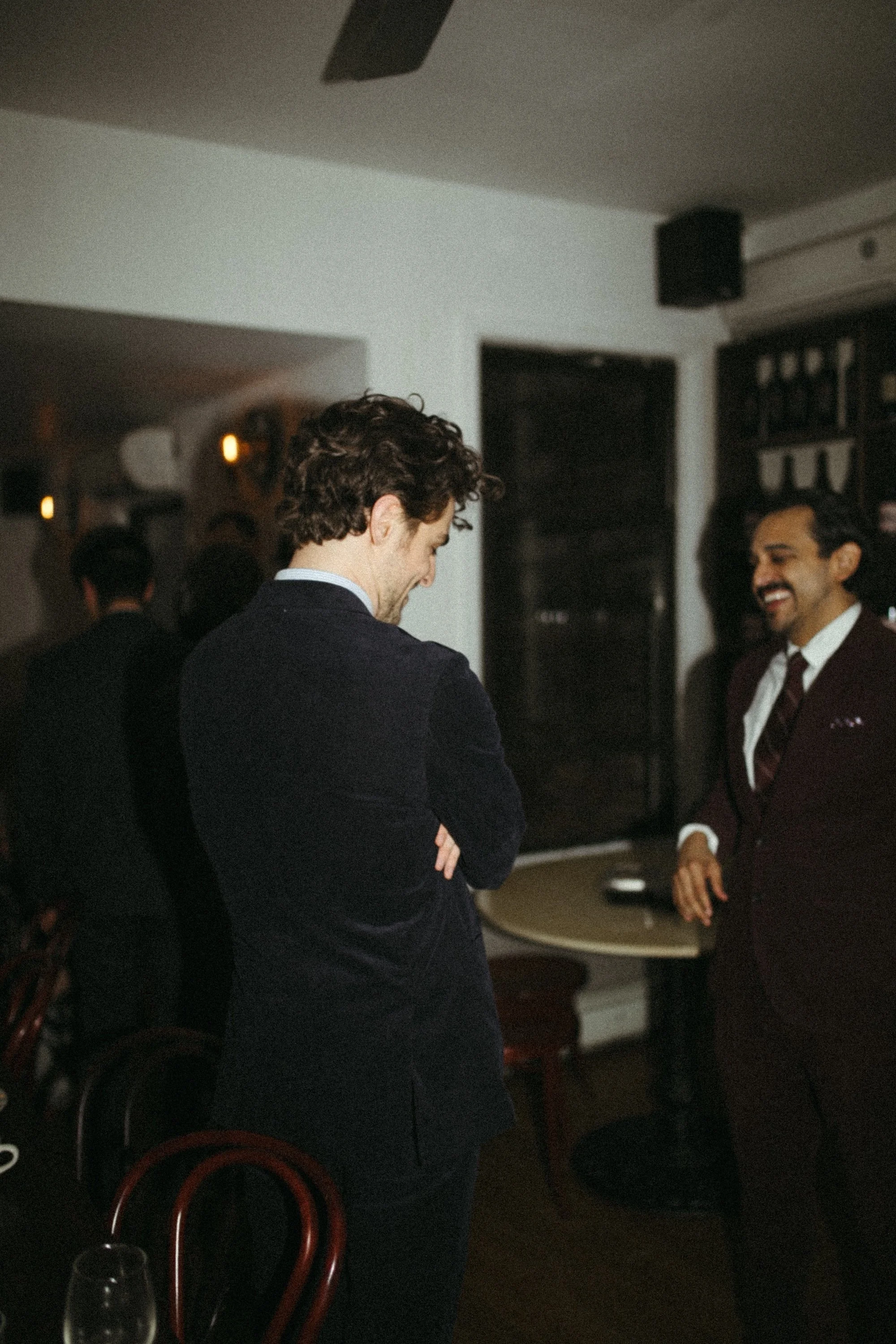 Two GWG colleagues sharing a laugh during an evening reception.