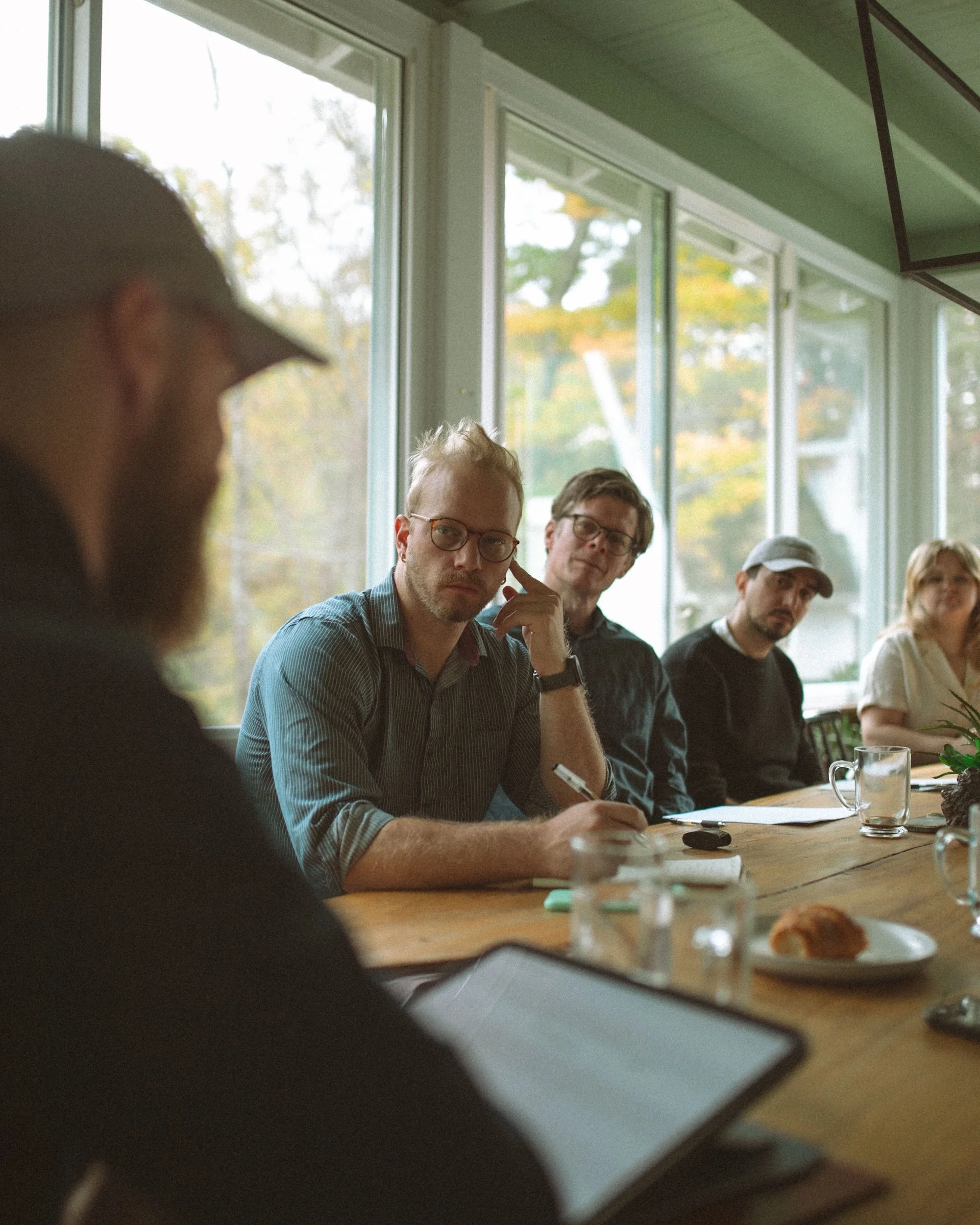 Gilliam Writers Group faculty listening attentively during a workshop session.