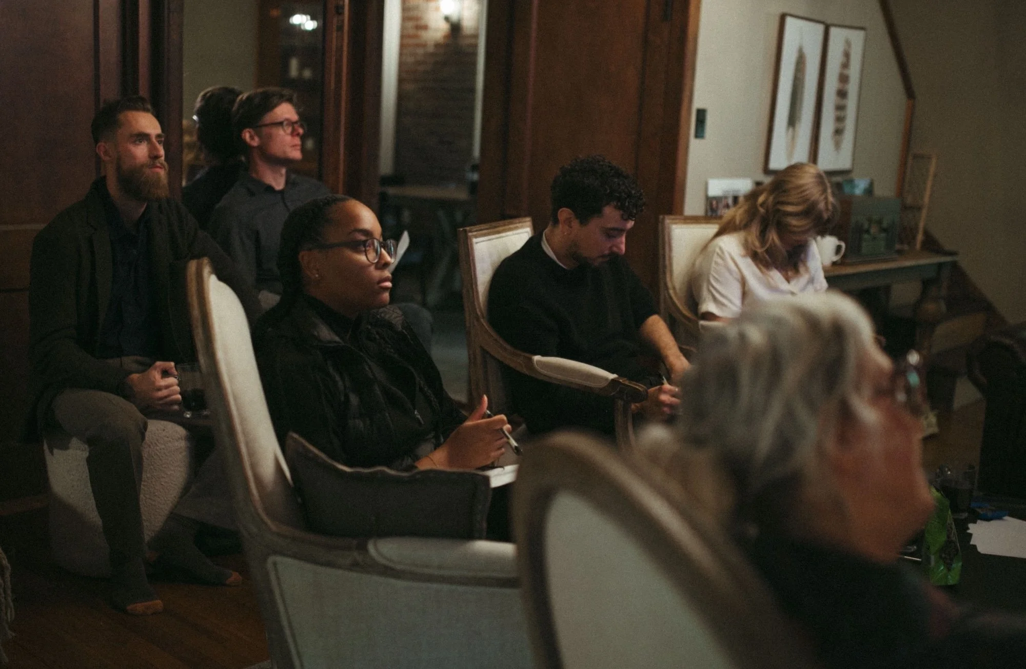 Gilliam Writers Group faculty listening and writing during a retreat workshop.