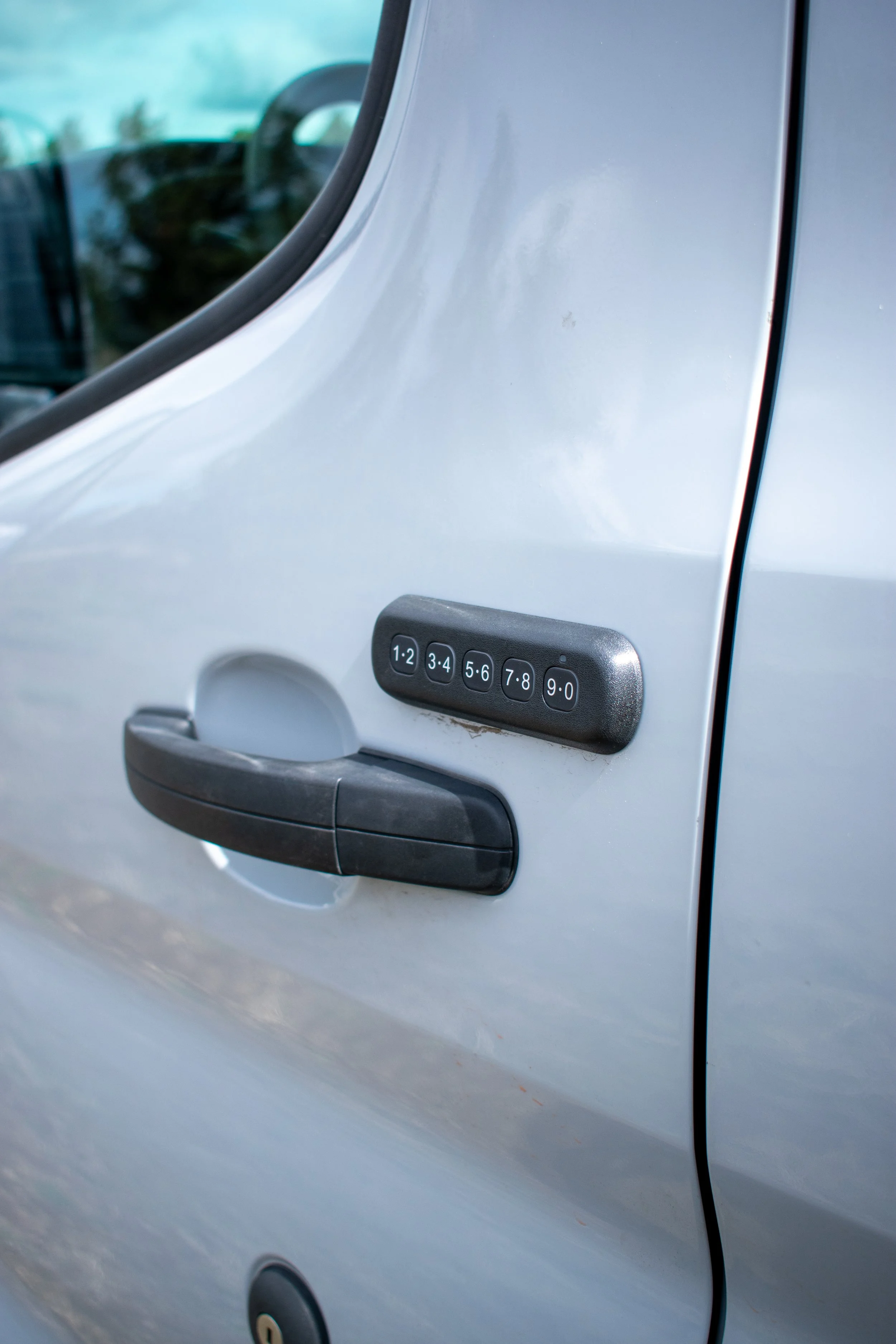 Ford Transit van with keypad locking entry – off-grid camper conversion by Oxbow Vans